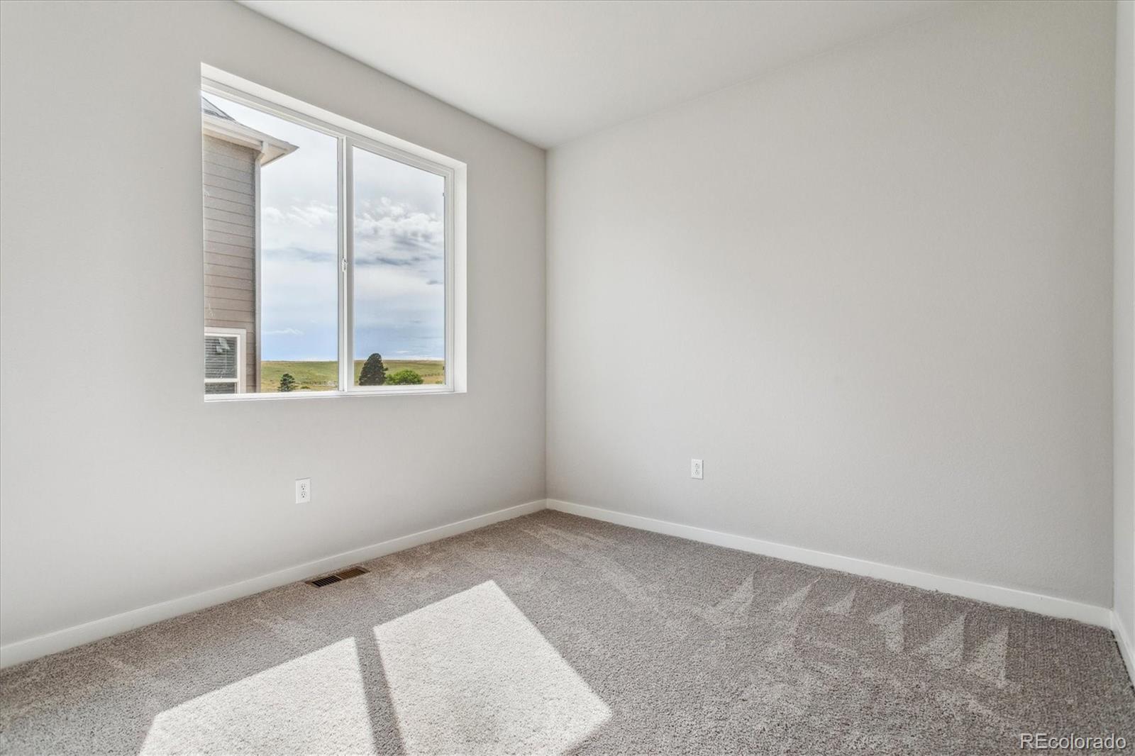 4255 Gozzer Ranch Drive Elizabeth, CO 80107 - Photo 9 of 21 an empty room with a window