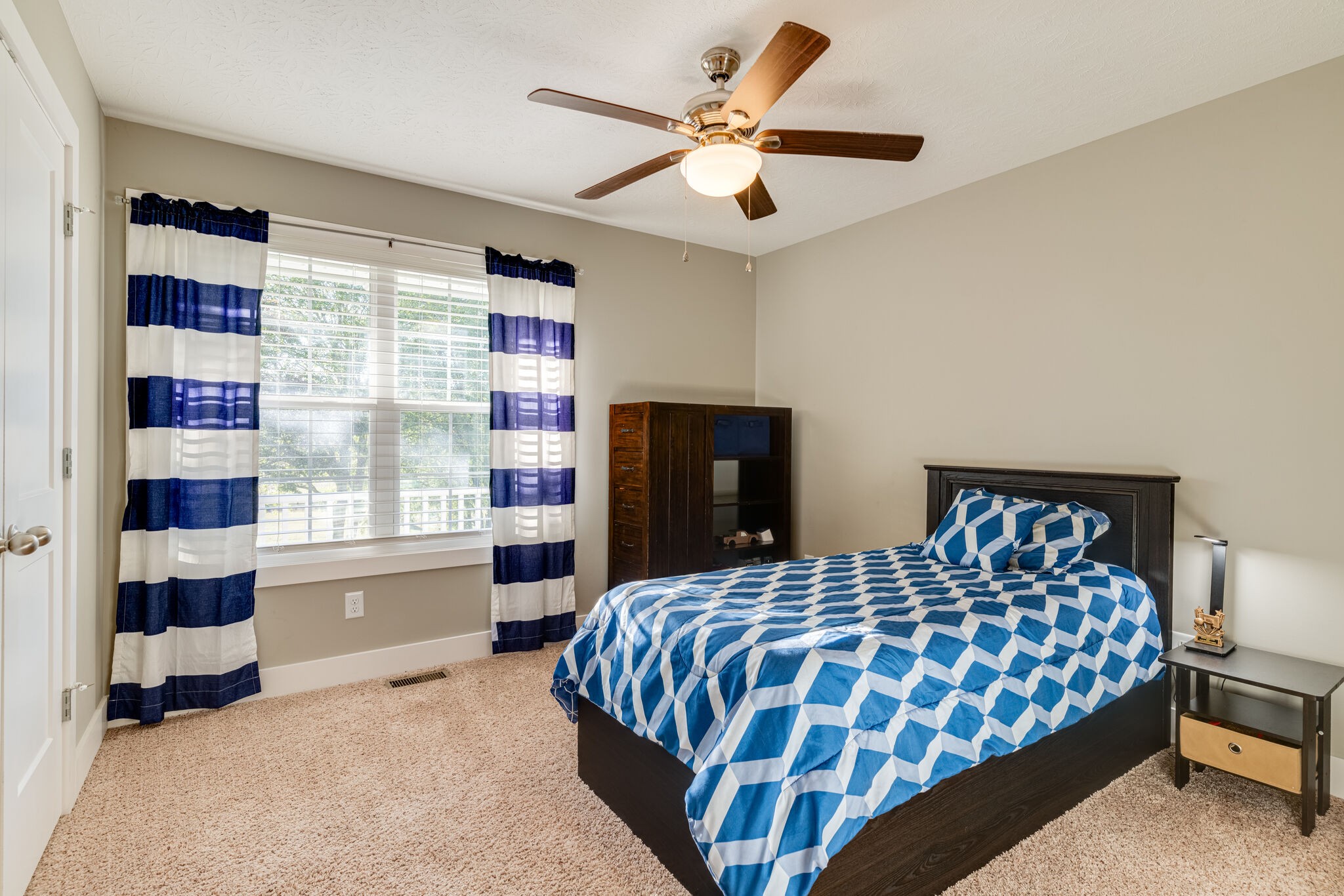 1688 Rock Bridge Road Bethpage, TN 37022 - Photo 14 of 29 a bedroom with a large bed and a chandelier