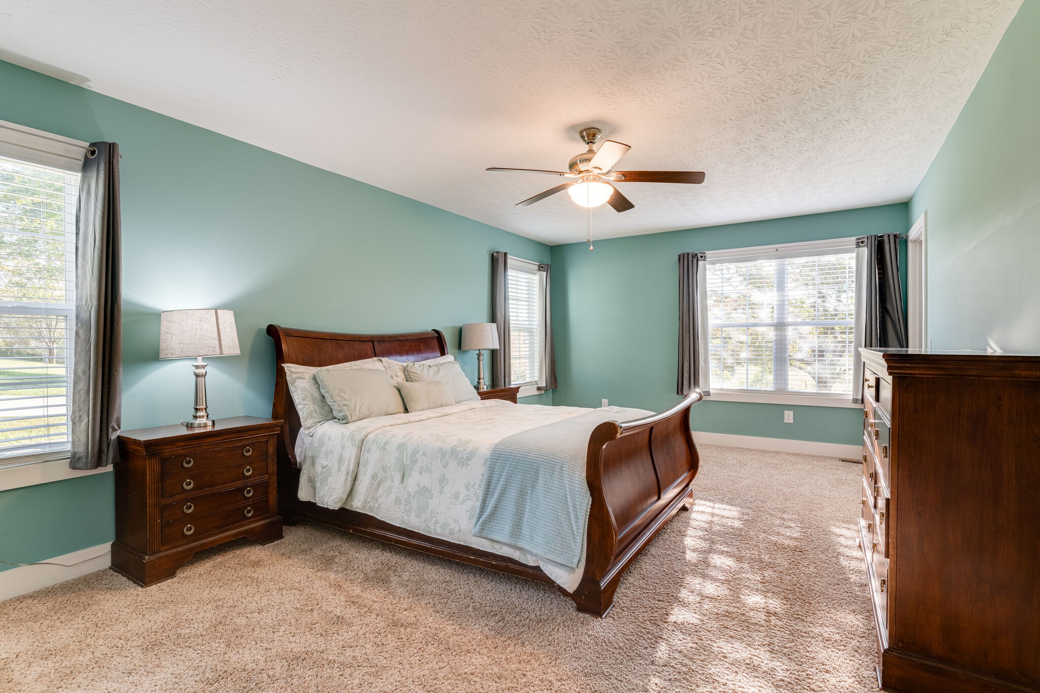 1688 Rock Bridge Road Bethpage, TN 37022 - Photo 17 of 29 a spacious bedroom with a large bed and a chandelier