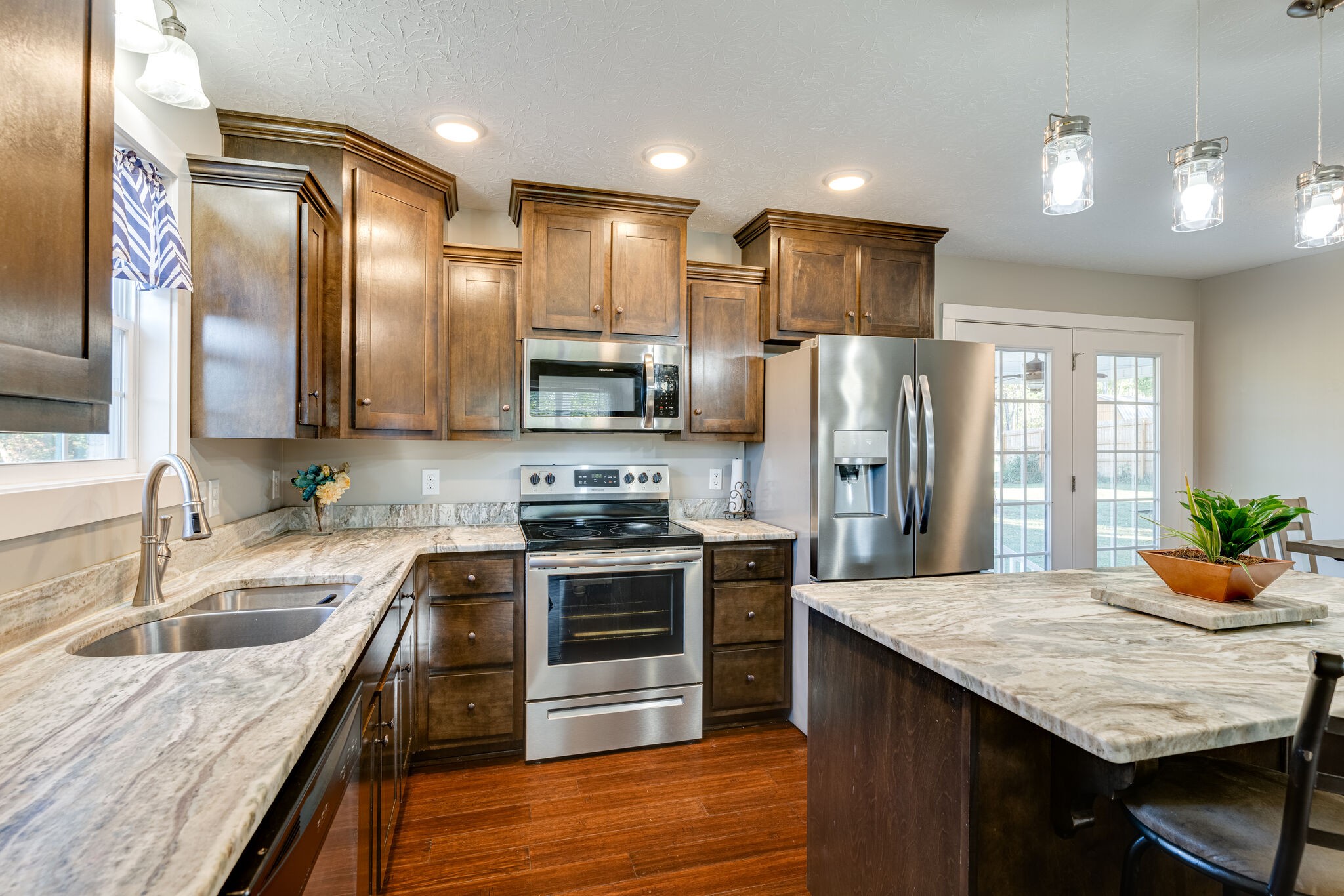 1688 Rock Bridge Road Bethpage, TN 37022 - Photo 10 of 29 a kitchen with stainless steel appliances granite countertop a sink stove and refrigerator