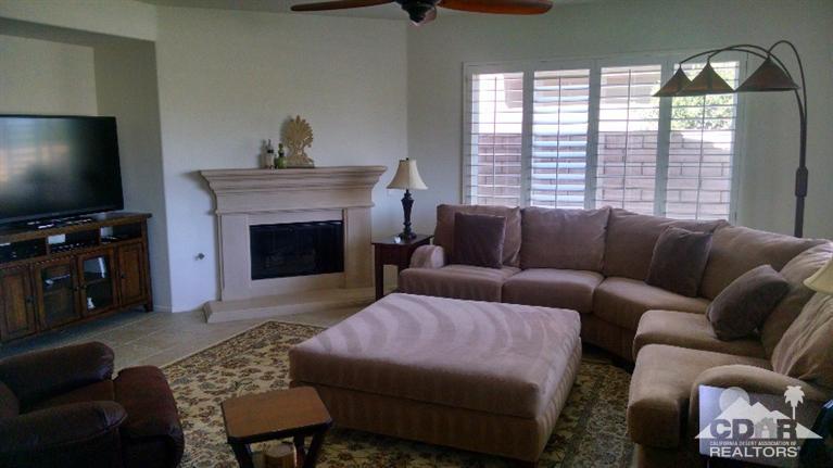 84740 Pavone Way Indio, CA 92203 - Photo 8 of 42 a living room with furniture a flat screen tv and a fireplace