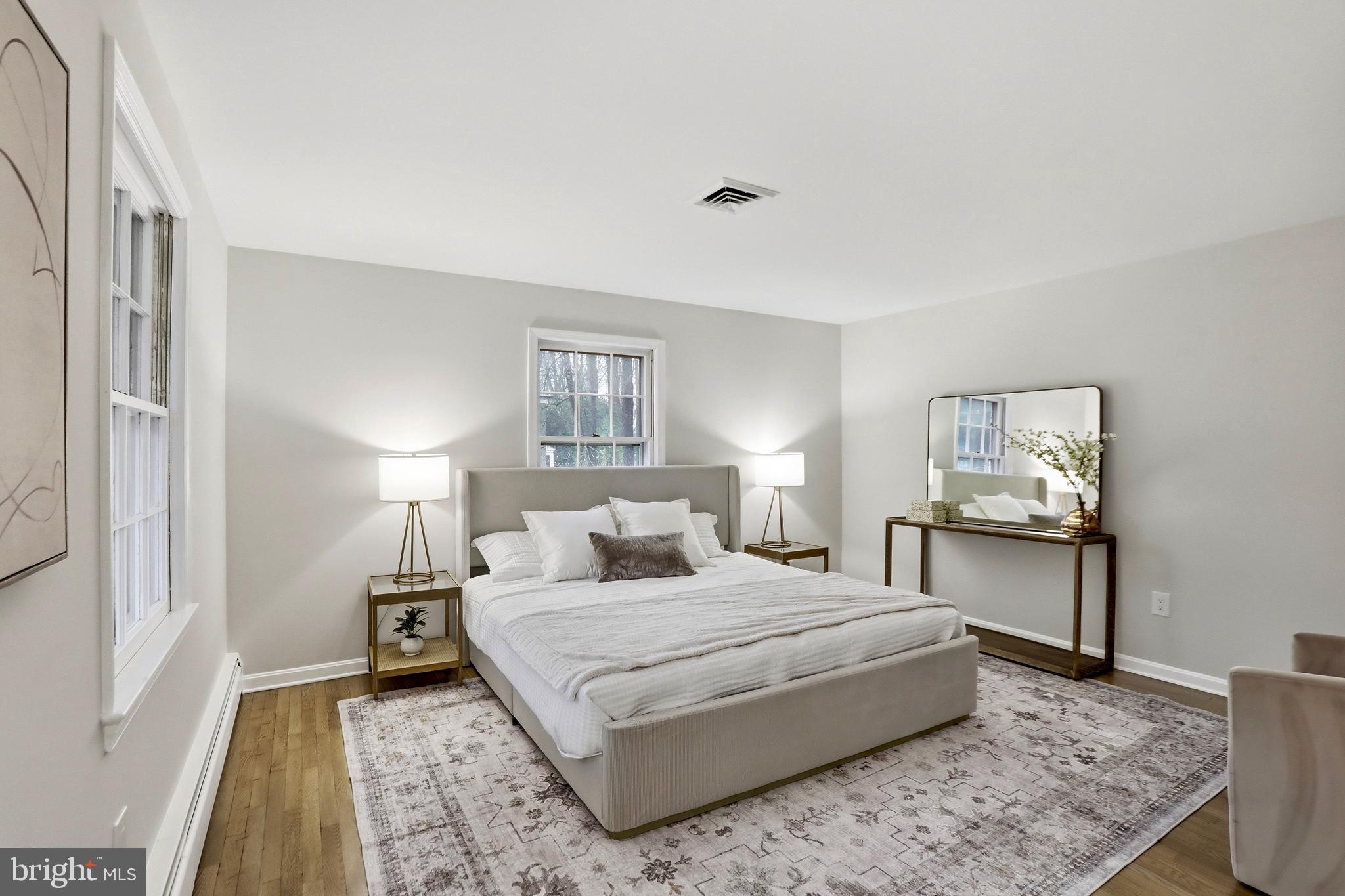 11328 Vale Road Oakton, VA 22124 - Photo 14 of 34 a bedroom with a large bed and a table