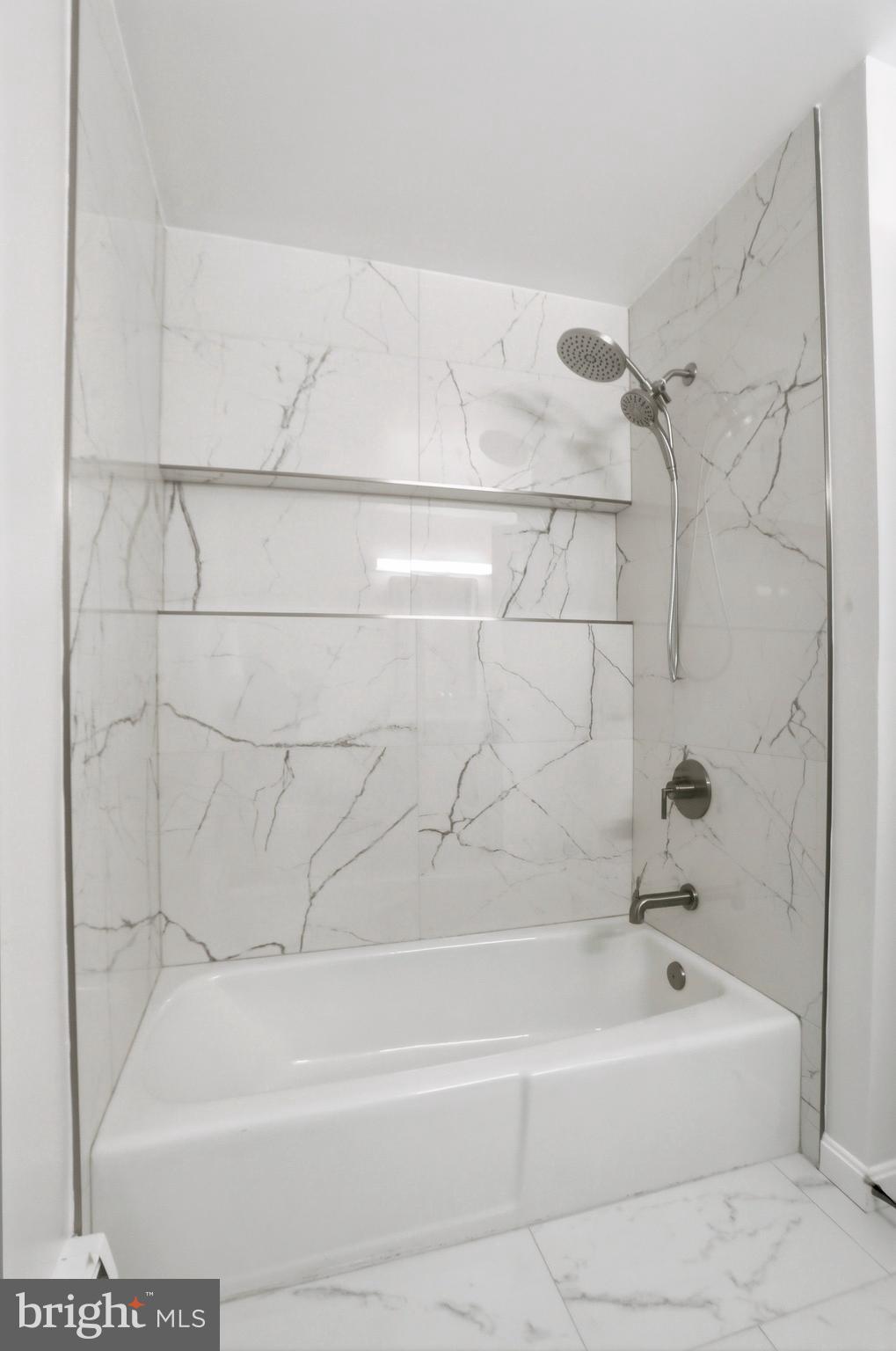 11328 Vale Road Oakton, VA 22124 - Photo 19 of 34 a bathroom with a bathtub