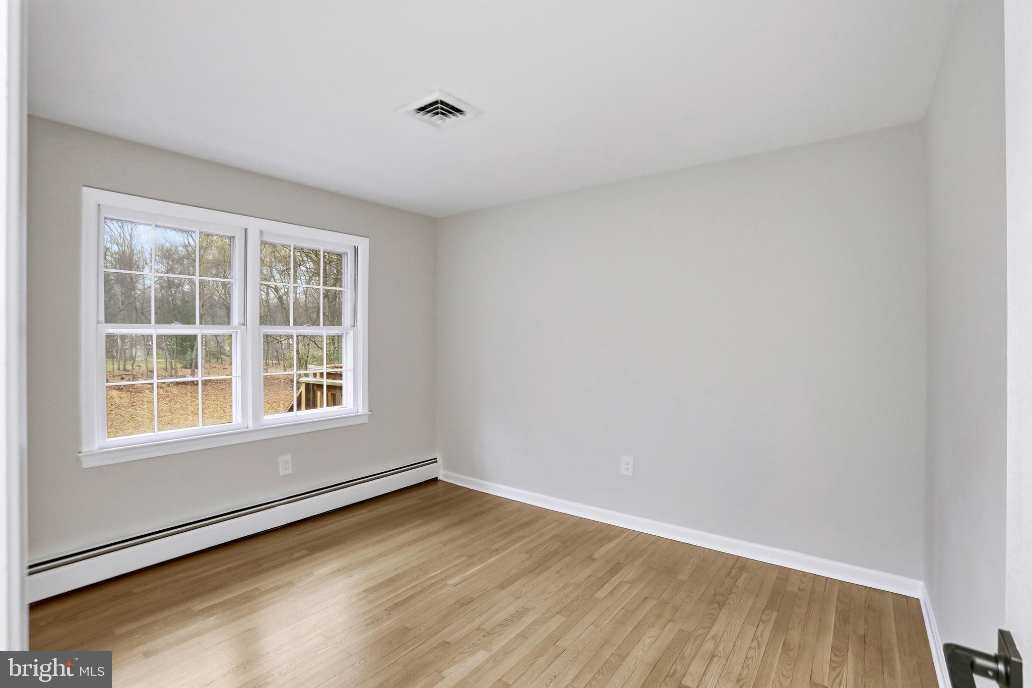 11328 Vale Road Oakton, VA 22124 - Photo 20 of 34 an empty room with wooden floor and windows
