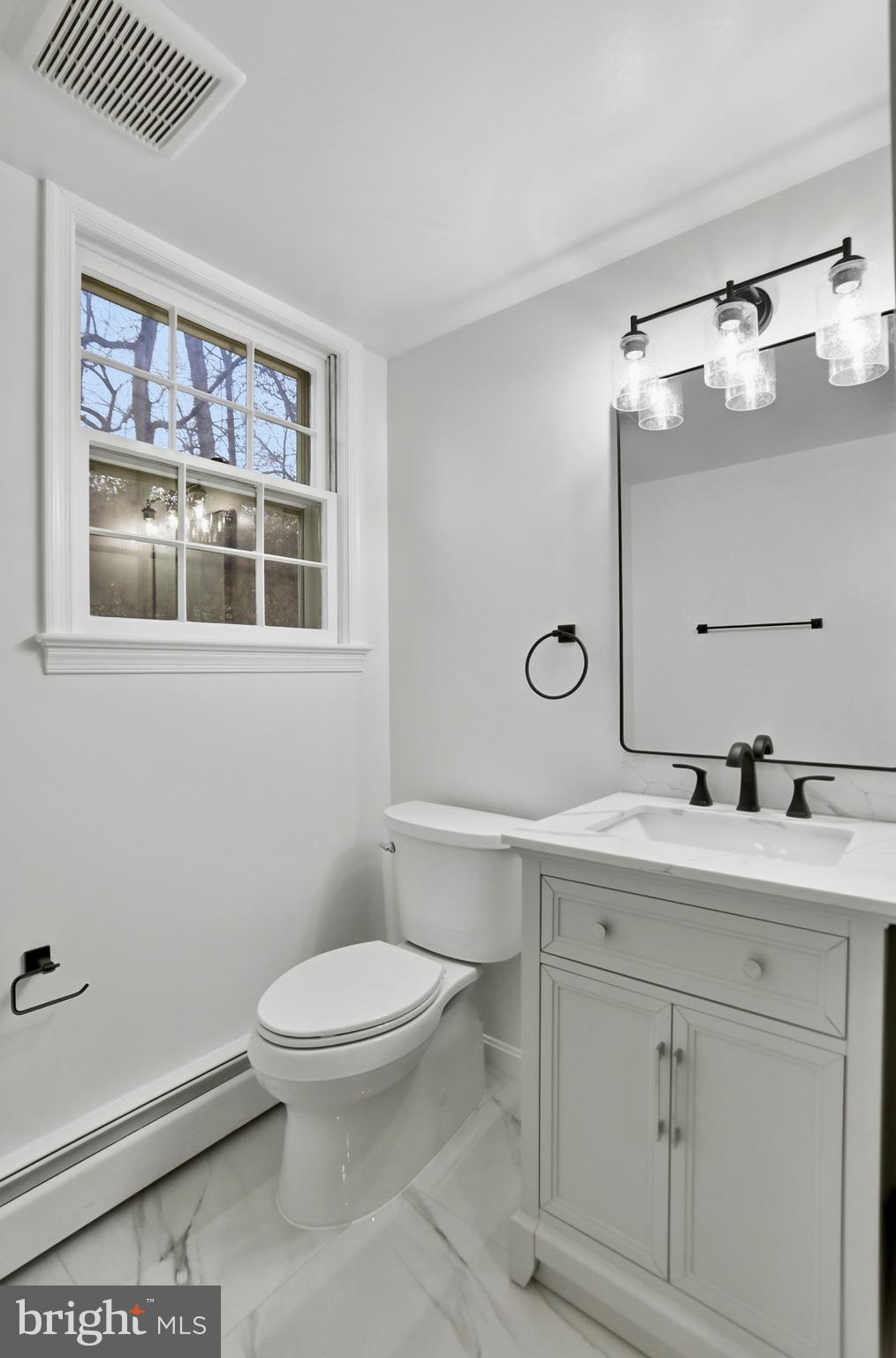 11328 Vale Road Oakton, VA 22124 - Photo 23 of 34 a bathroom with a toilet a sink and mirror