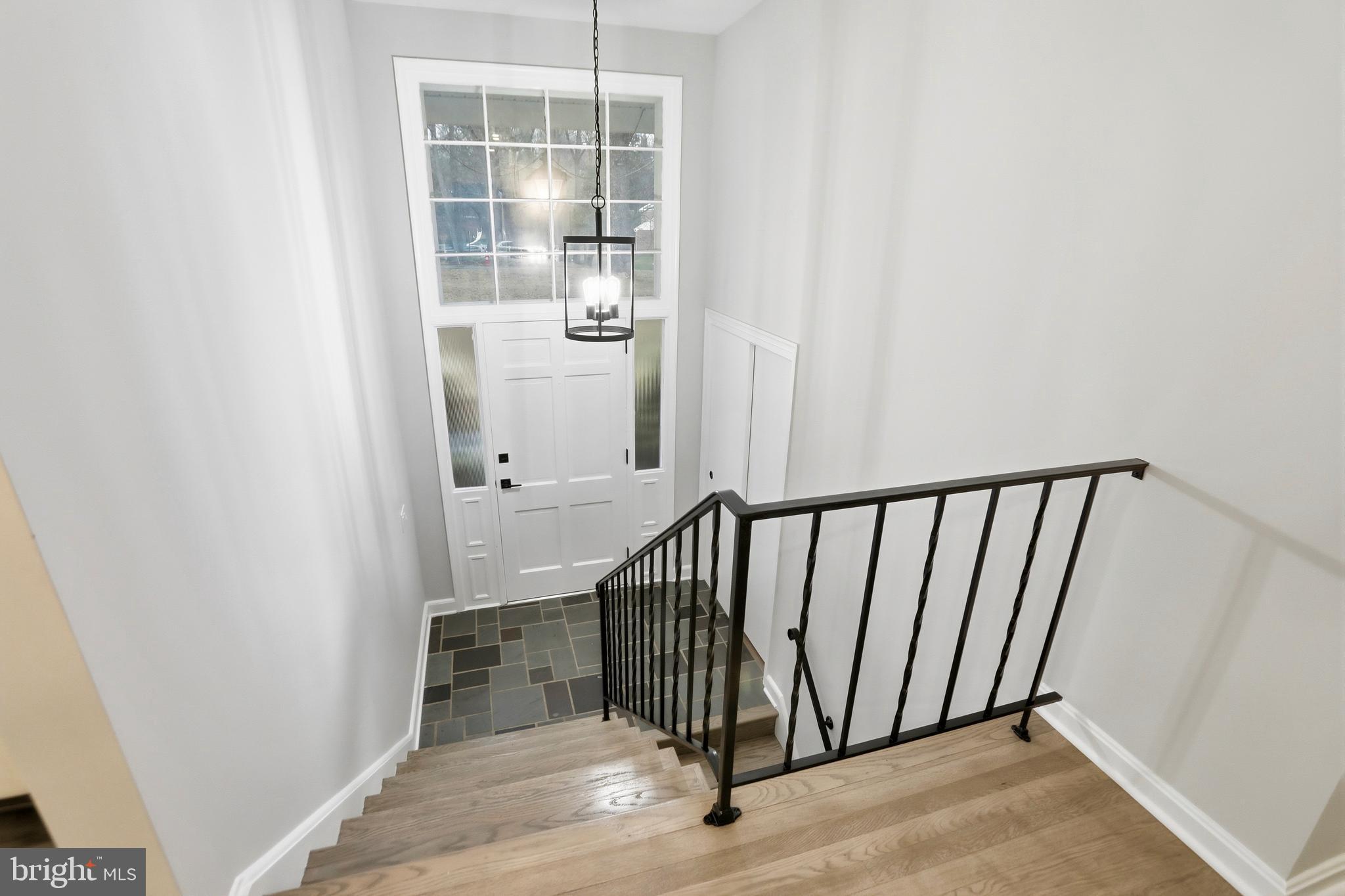 11328 Vale Road Oakton, VA 22124 - Photo 3 of 34 a view of a hallway with wooden floor and staircase