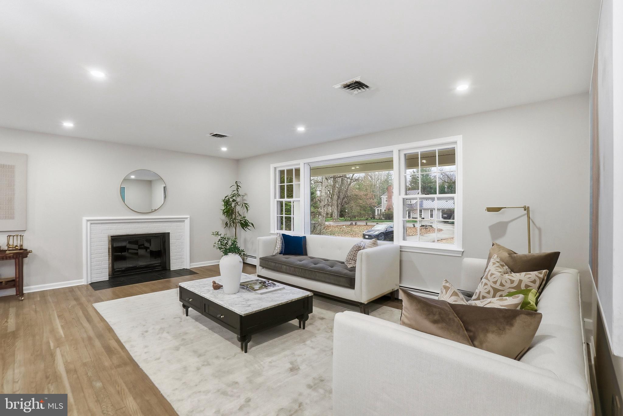 11328 Vale Road Oakton, VA 22124 - Photo 5 of 34 a living room with furniture and a fireplace