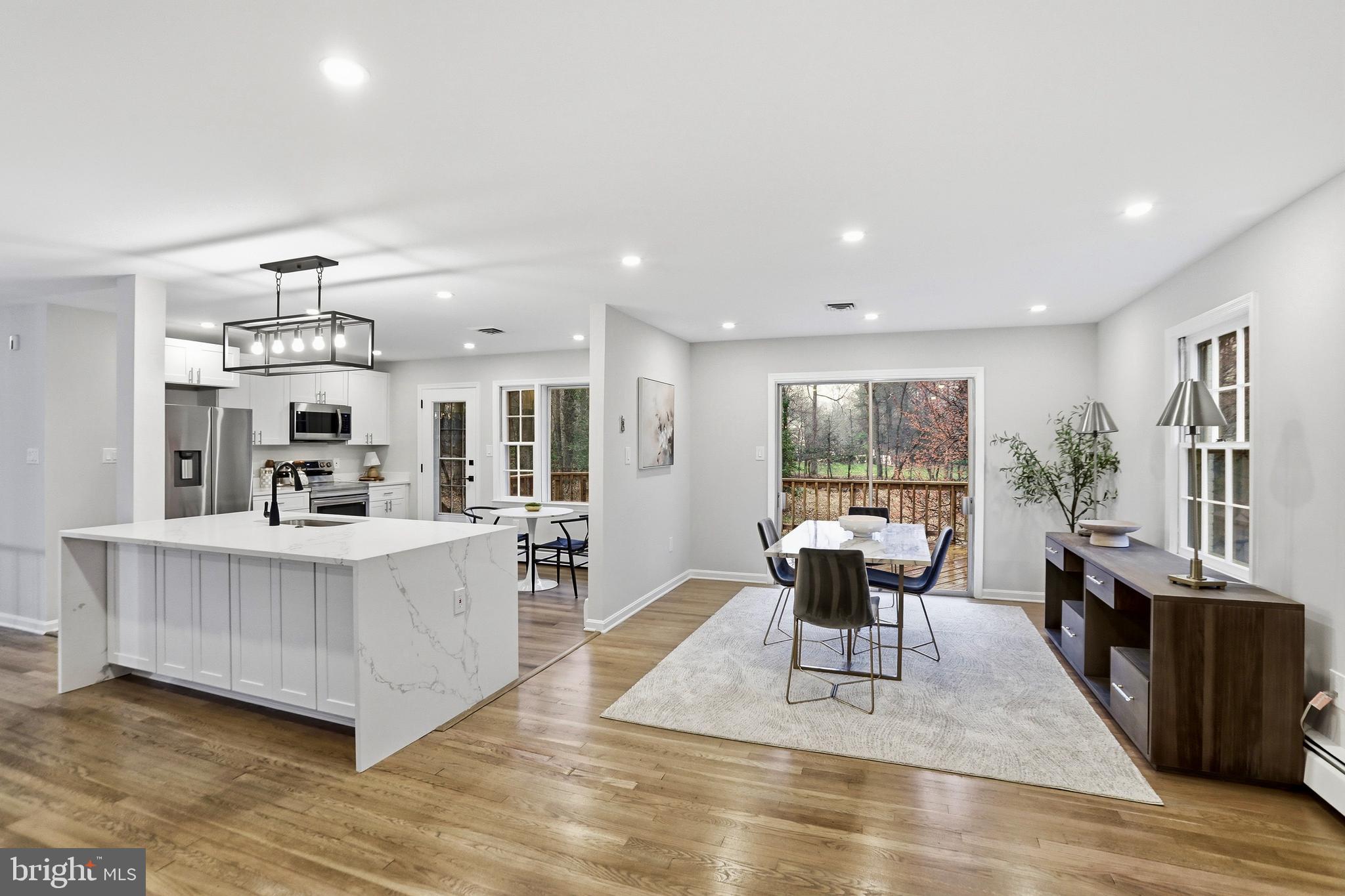 11328 Vale Road Oakton, VA 22124 - Photo 7 of 34 a living room with furniture a large window and wooden floor