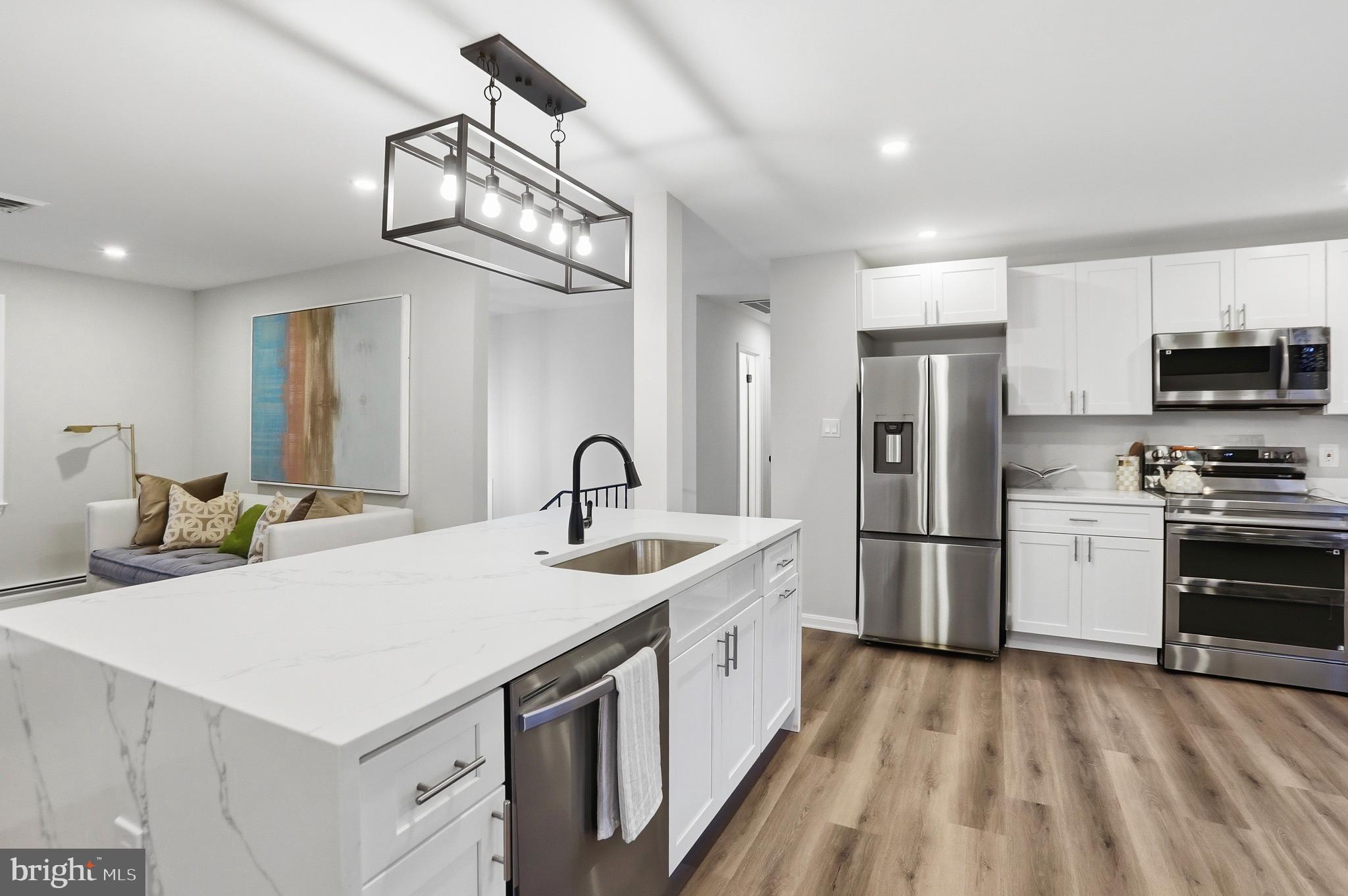 11328 Vale Road Oakton, VA 22124 - Photo 9 of 34 a kitchen that has a lot of cabinets a sink and a stove