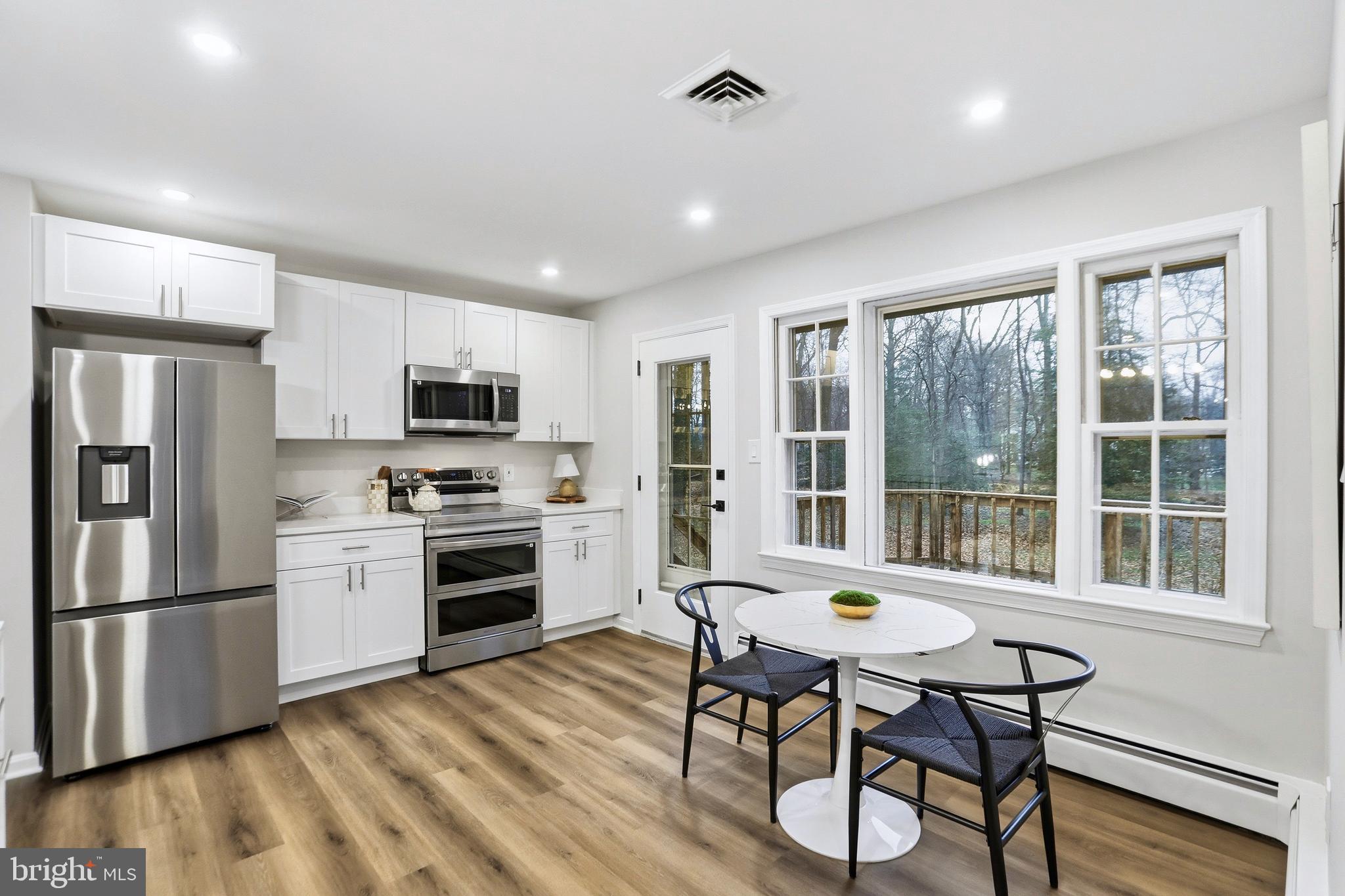 11328 Vale Road Oakton, VA 22124 - Photo 10 of 34 a kitchen with sink a refrigerator and chairs