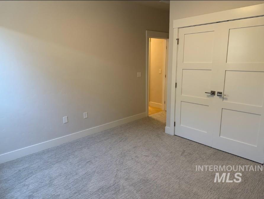 665 West Wrangler Street Meridian, ID 83646 - Photo 7 of 18 Neutral-toned room with light gray carpet flooring and white baseboards