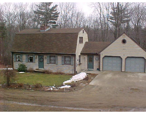 a view of a house with pool and sitting area