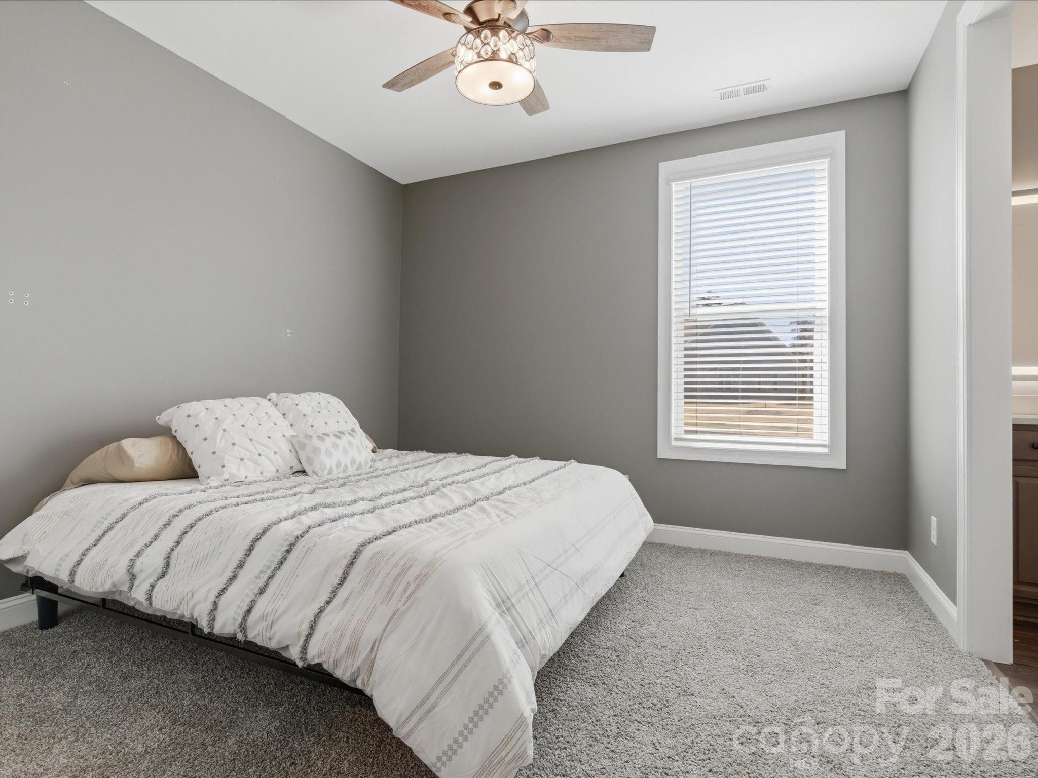 7004 Treetop Court York, SC 29745 - Photo 16 of 47 a bedroom with a bed and a window