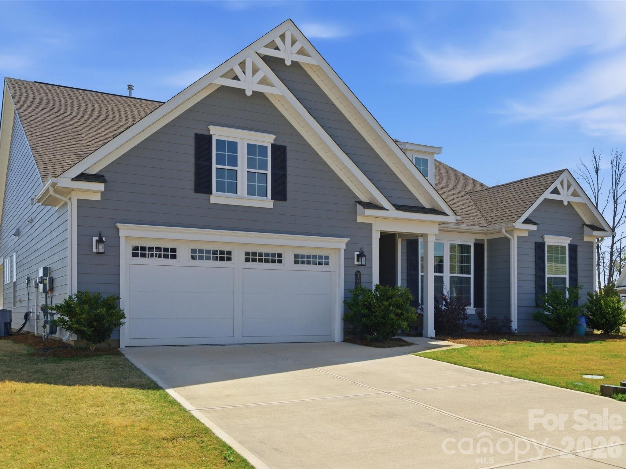 7004 Treetop Court York, SC 29745 - Photo 2 of 47 a front view of a house with a yard and garage
