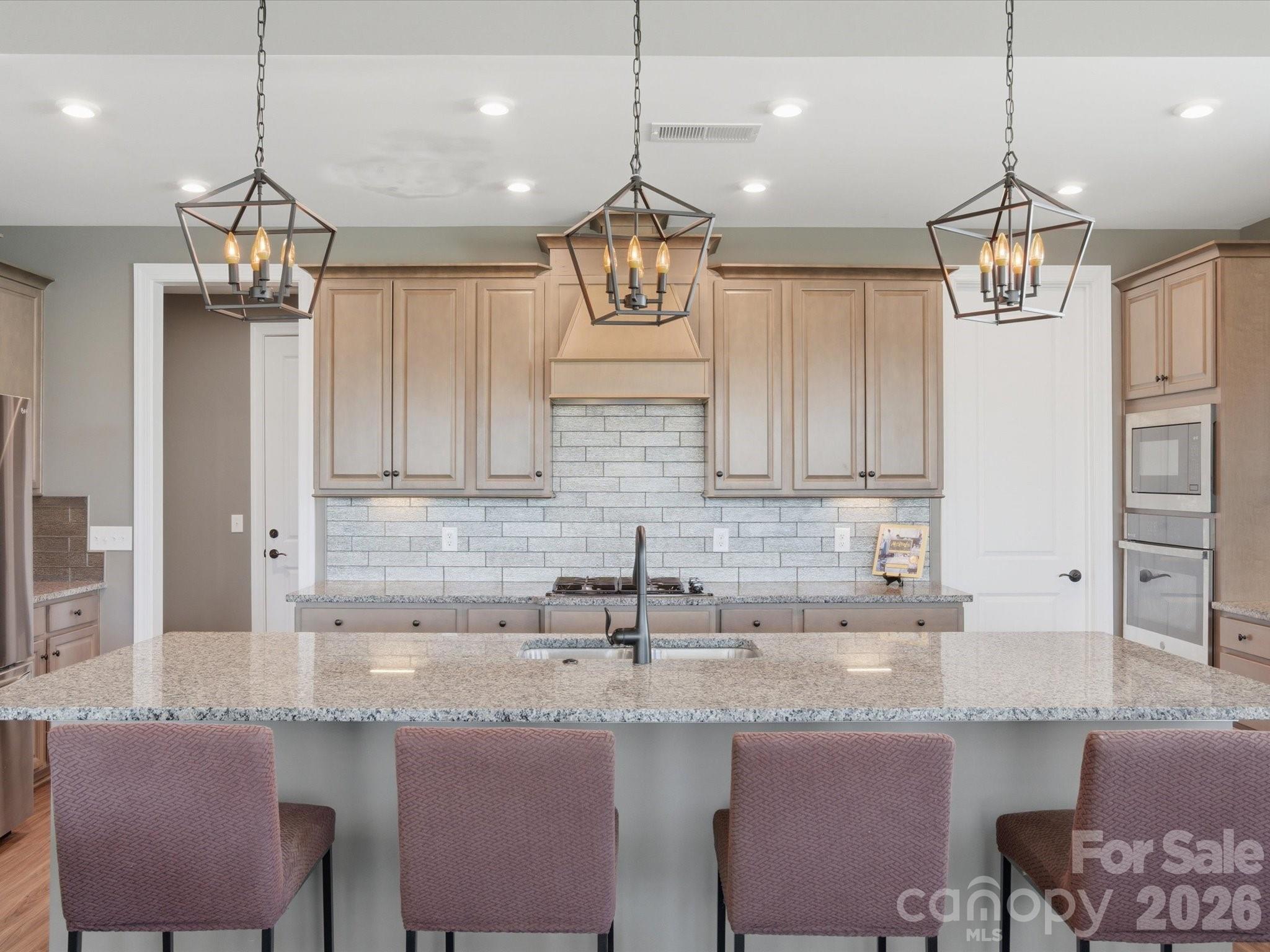 7004 Treetop Court York, SC 29745 - Photo 24 of 47 a kitchen with stainless steel appliances granite countertop a sink stove and refrigerator