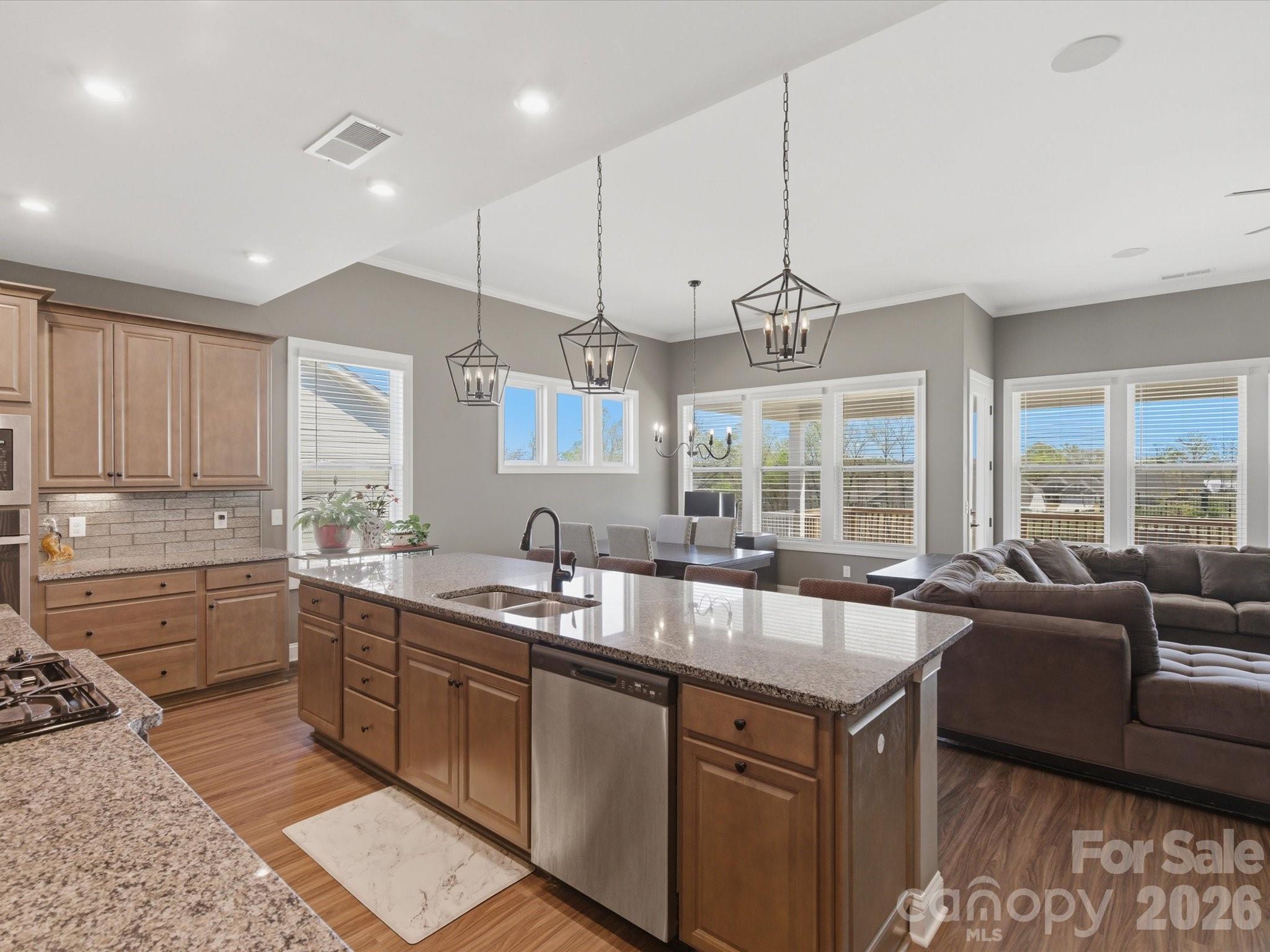 7004 Treetop Court York, SC 29745 - Photo 26 of 47 a kitchen with granite countertop a sink and white cabinets