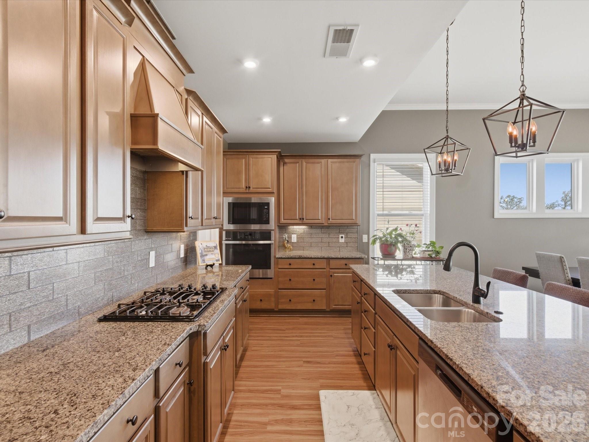 7004 Treetop Court York, SC 29745 - Photo 27 of 47 a kitchen with stainless steel appliances granite countertop a sink stove and refrigerator