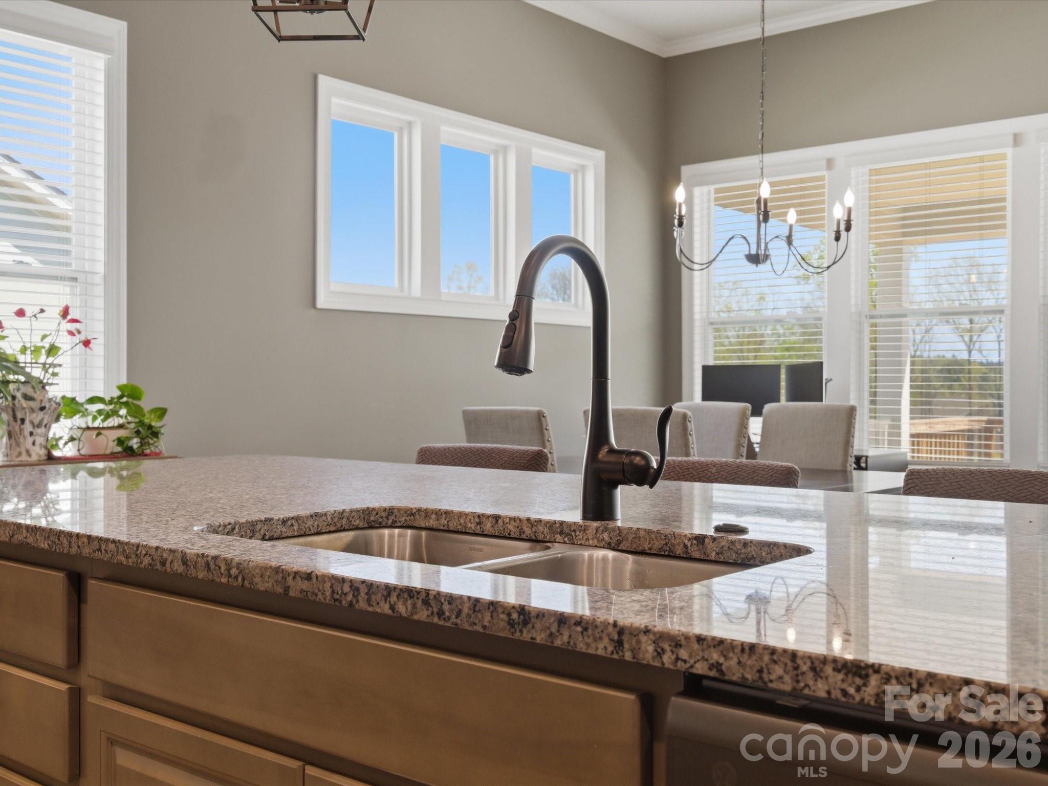 7004 Treetop Court York, SC 29745 - Photo 30 of 47 a kitchen with granite countertop a sink and a counter top space