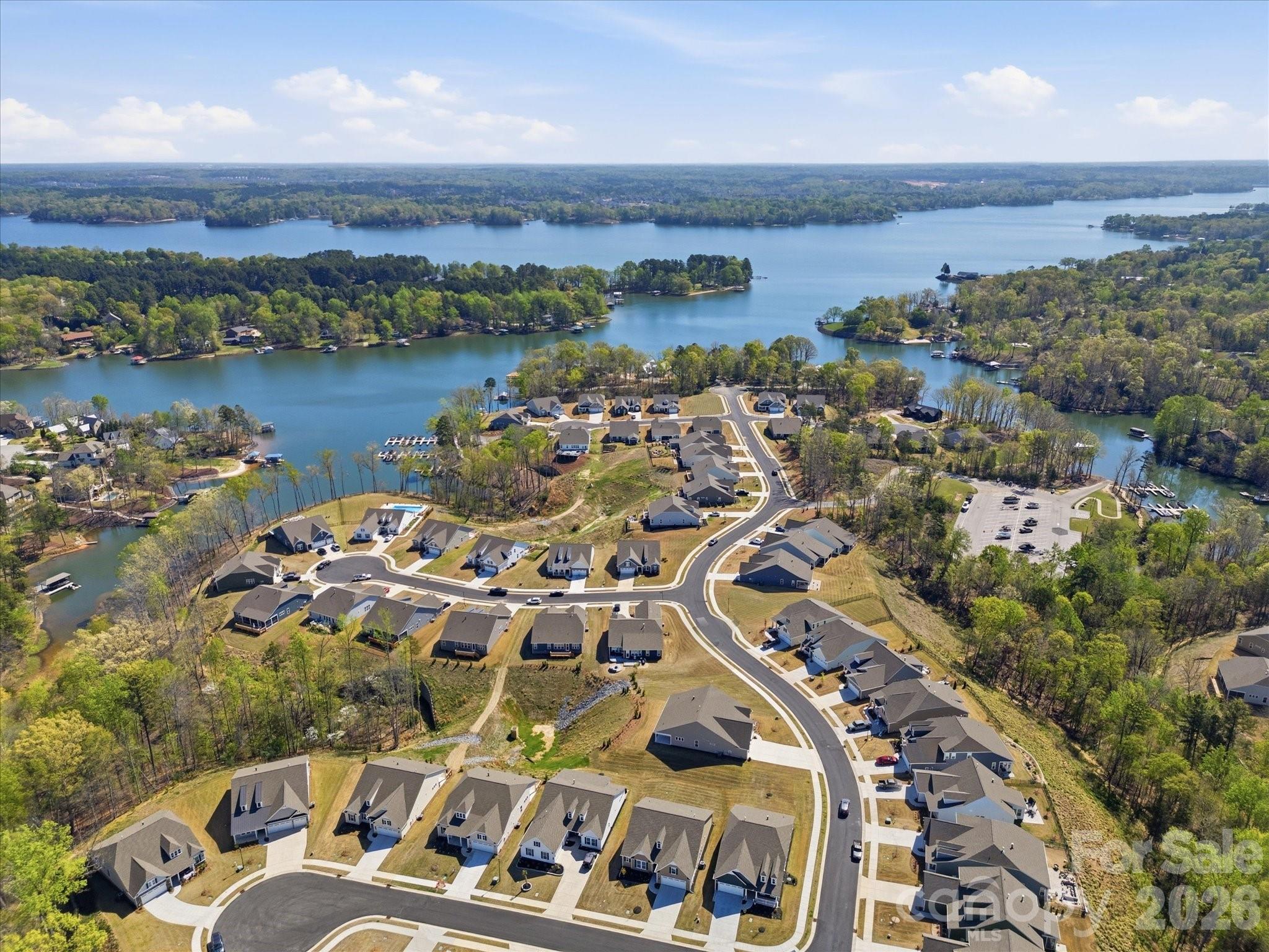 7004 Treetop Court York, SC 29745 - Photo 6 of 47 an aerial view of a city with lots of residential buildings and lake view in back