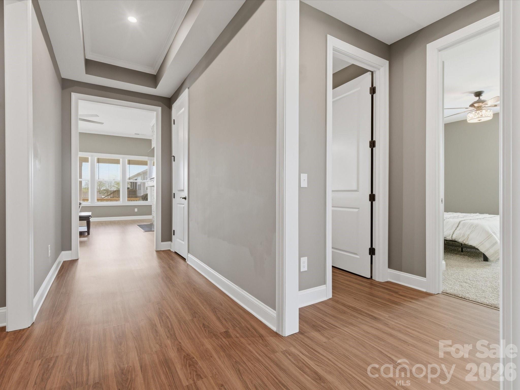 7004 Treetop Court York, SC 29745 - Photo 10 of 47 a view of a hallway with wooden floor and bathroom