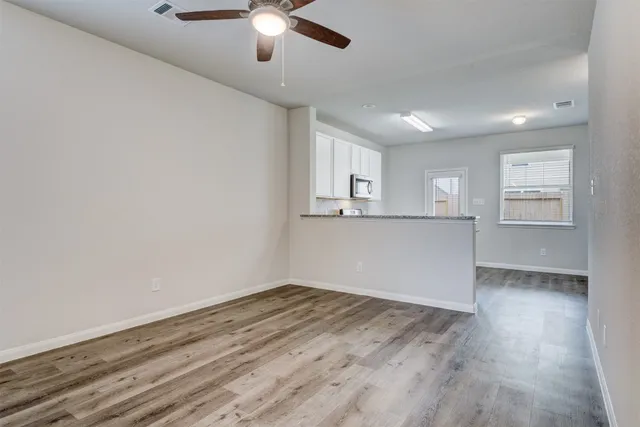 wooden floor in an empty room with a window