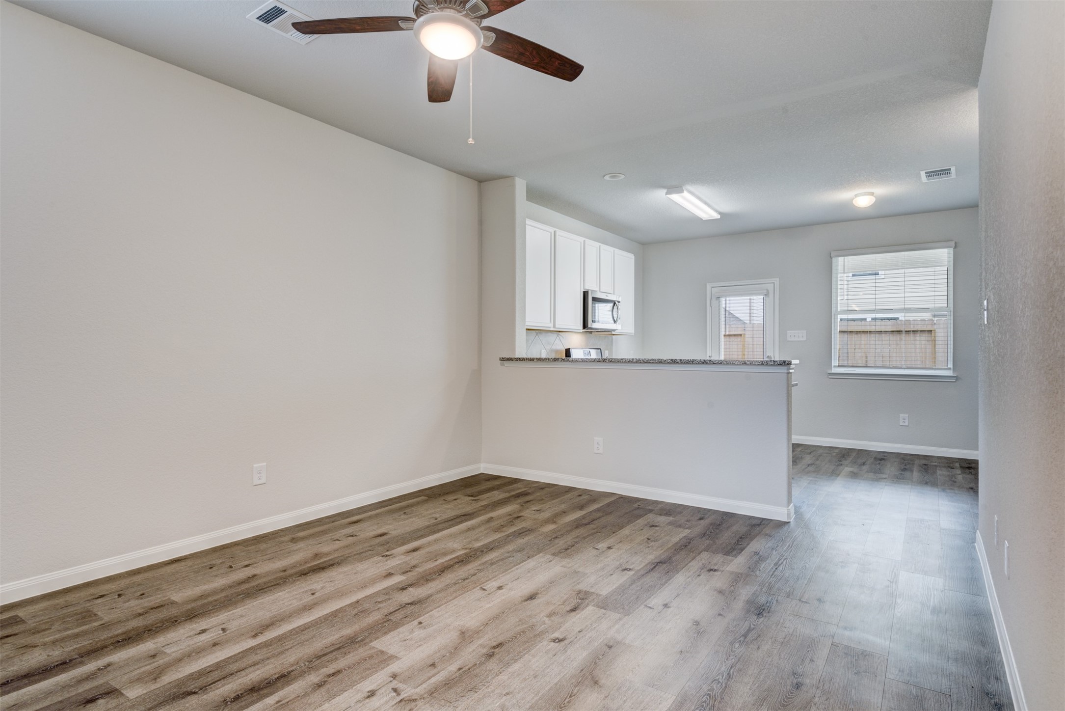5011 Blue Jacaranda Way Spring Spring, TX 77373 - Photo 11 of 32 wooden floor in an empty room with a window