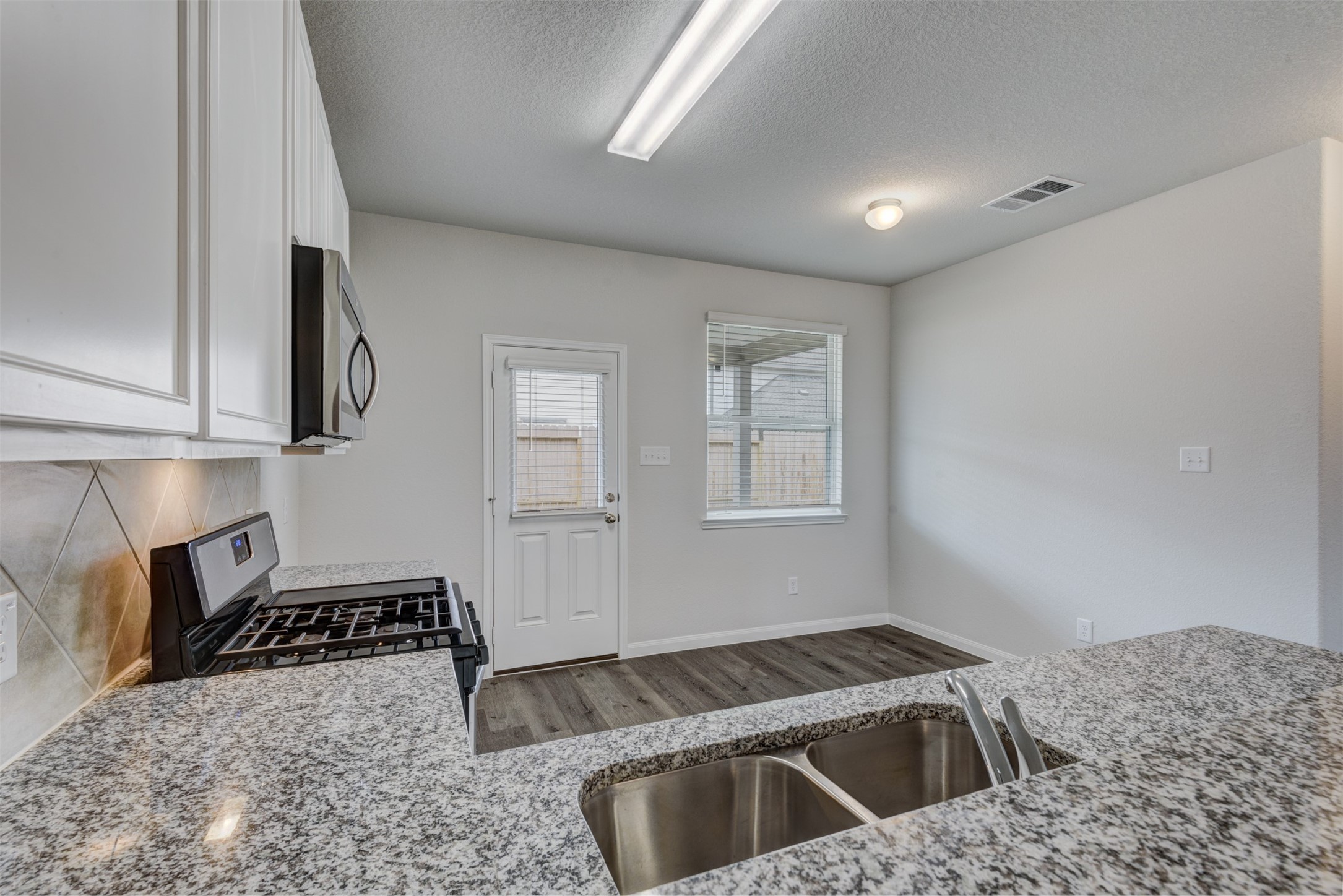 5011 Blue Jacaranda Way Spring Spring, TX 77373 - Photo 15 of 32 a kitchen that has a sink and a stove in it