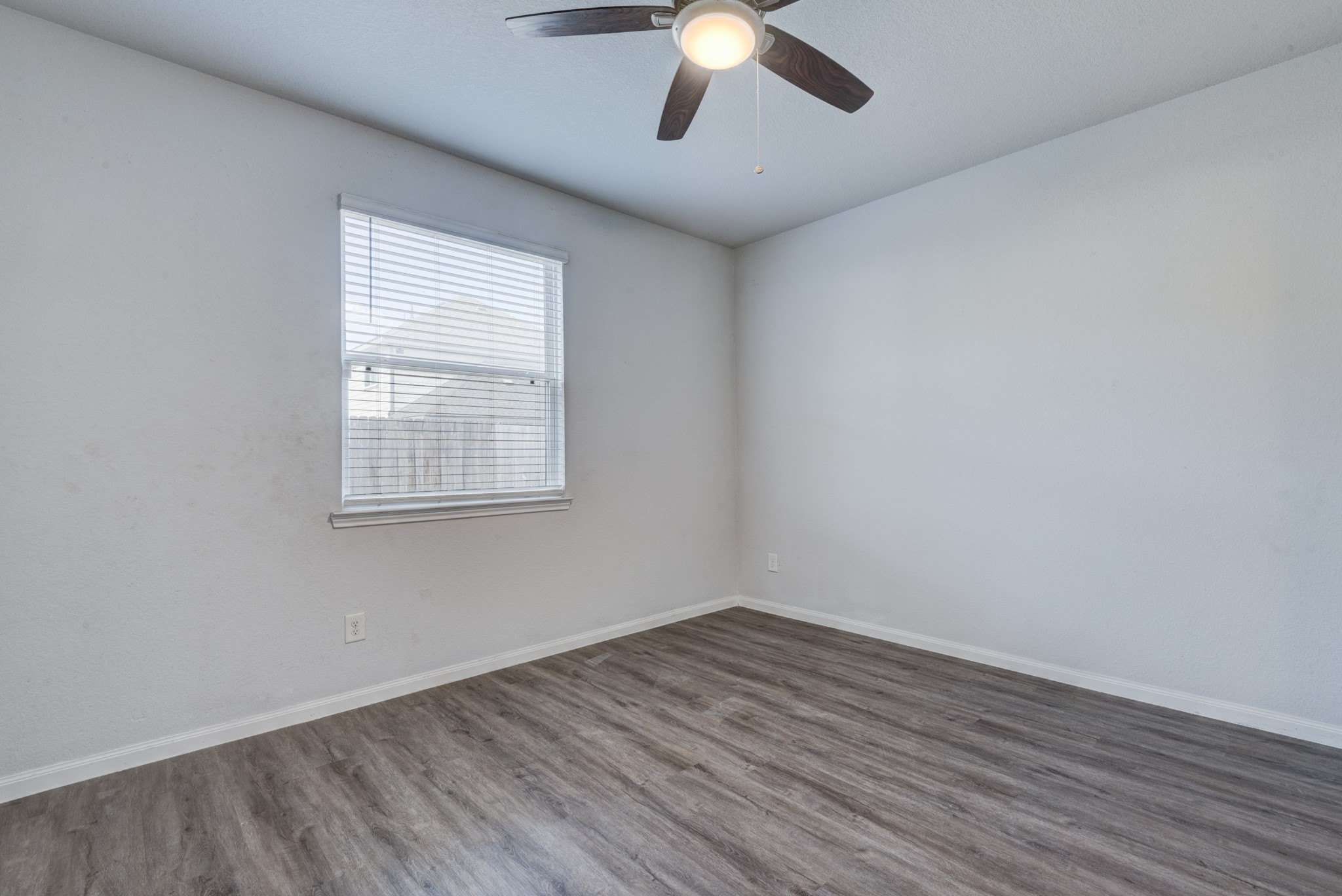 5011 Blue Jacaranda Way Spring Spring, TX 77373 - Photo 19 of 32 wooden floor in an empty room with a window