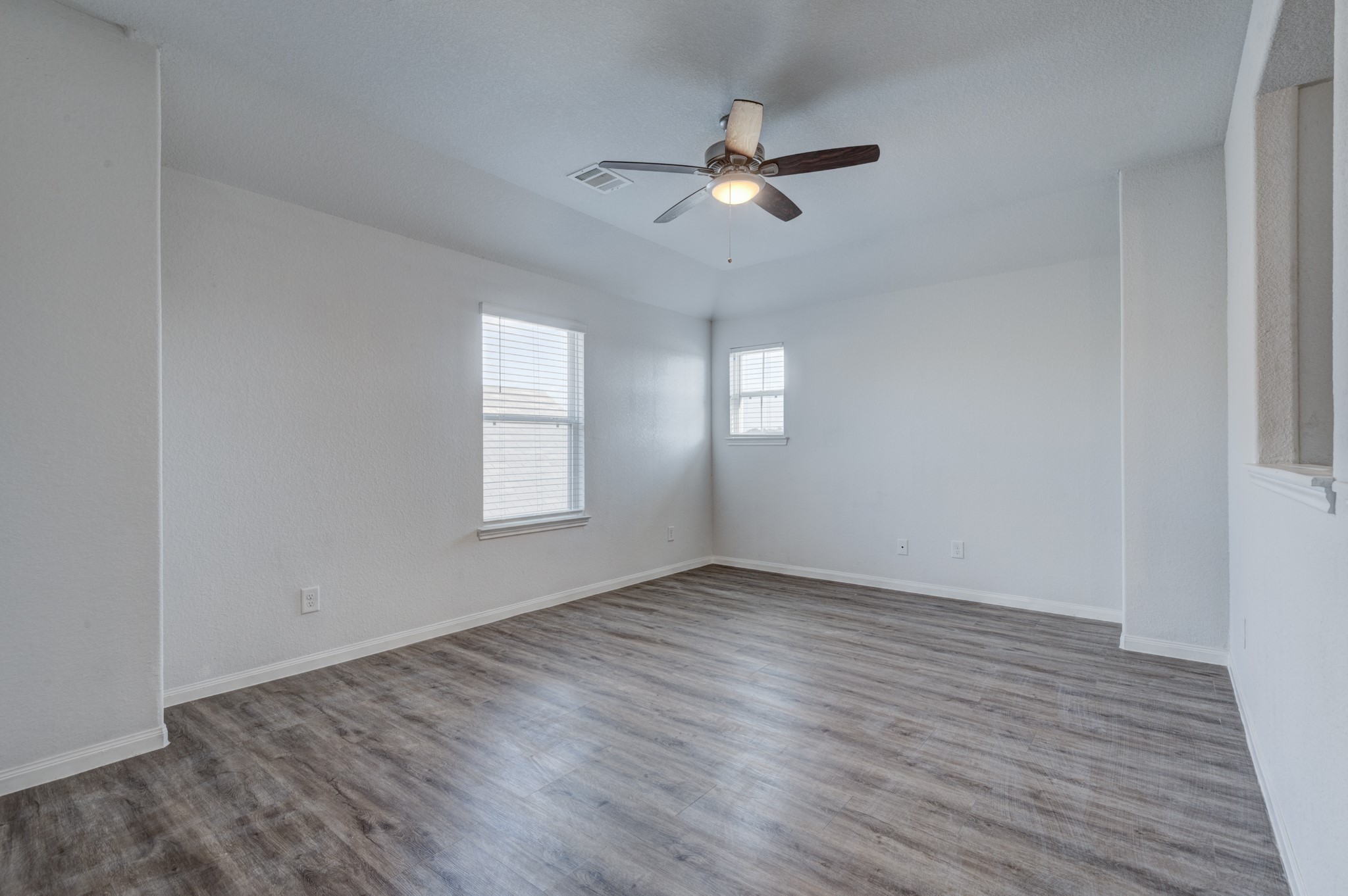 5011 Blue Jacaranda Way Spring Spring, TX 77373 - Photo 24 of 32 a view of an empty room with wooden floor and a window