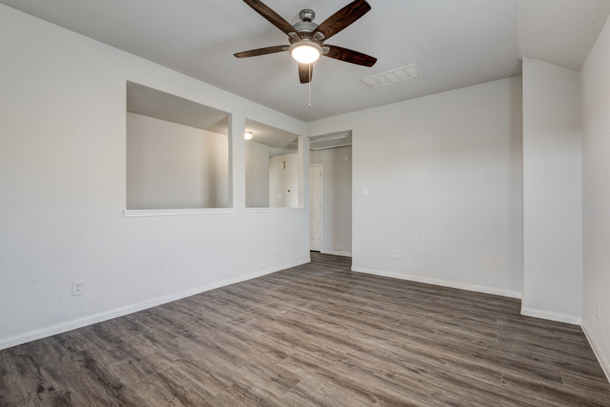5011 Blue Jacaranda Way Spring Spring, TX 77373 - Photo 25 of 32 a view of an empty room with window and wooden floor