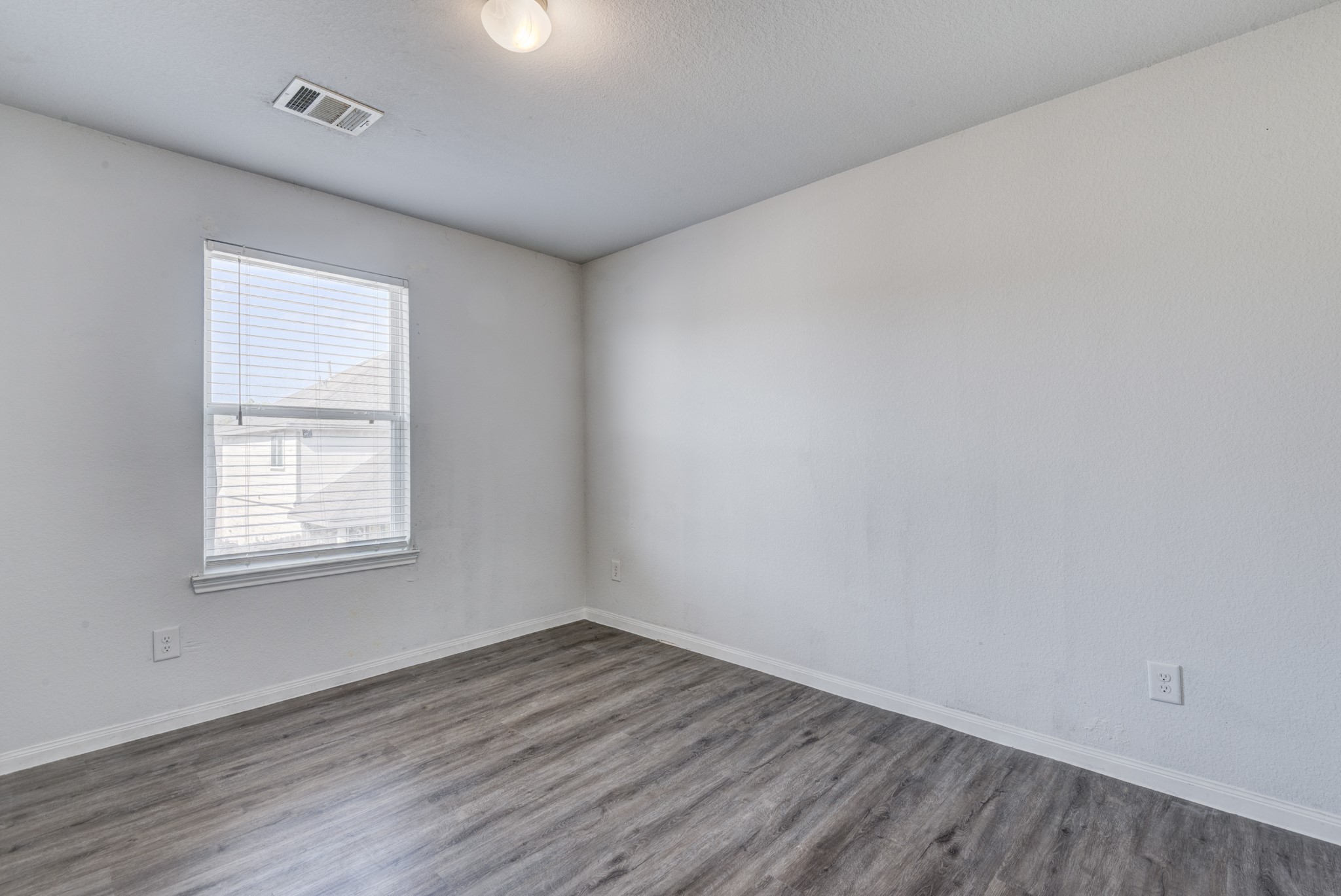 5011 Blue Jacaranda Way Spring Spring, TX 77373 - Photo 26 of 32 an empty room with wooden floor and windows