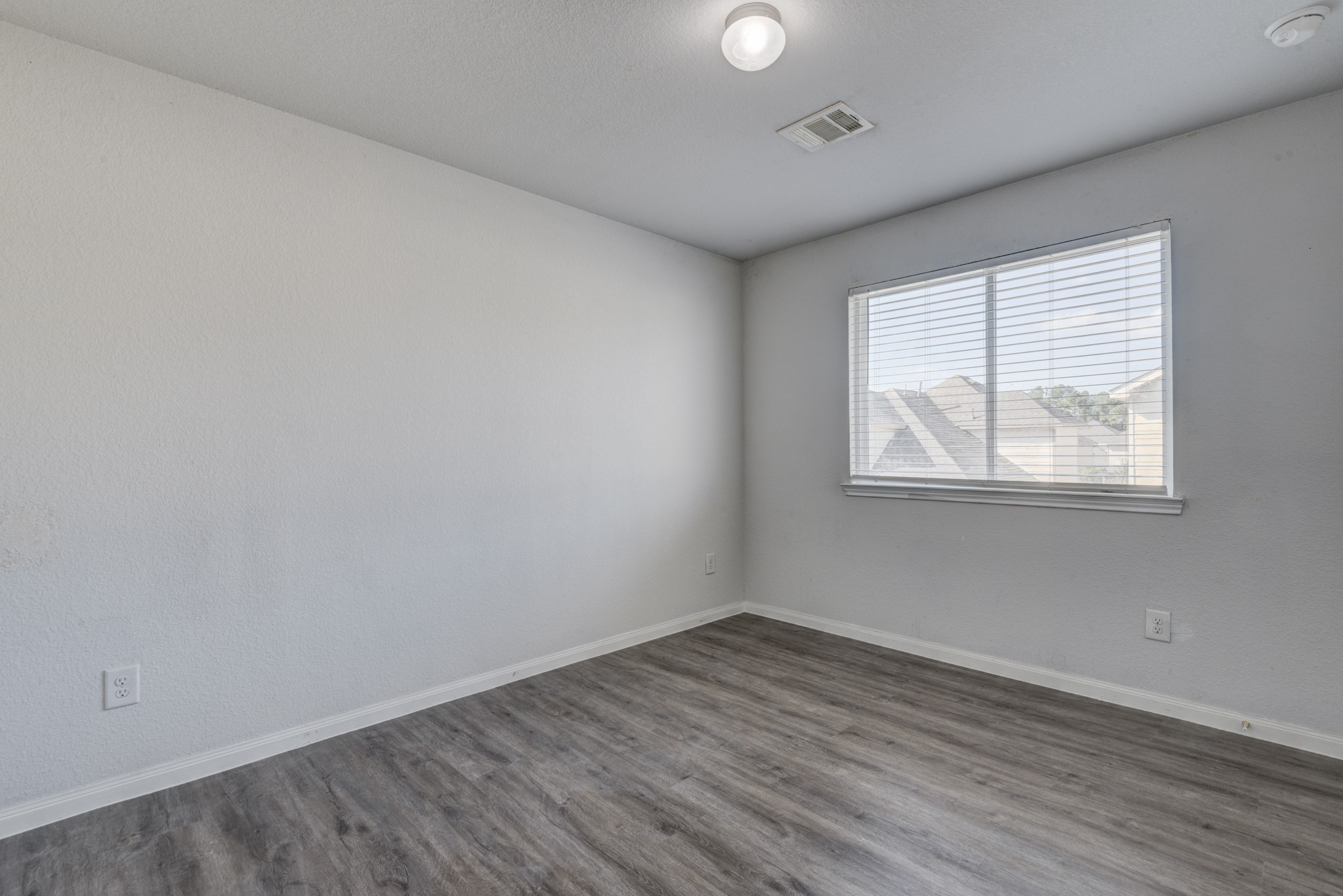 5011 Blue Jacaranda Way Spring Spring, TX 77373 - Photo 29 of 32 wooden floor in an empty room with a window