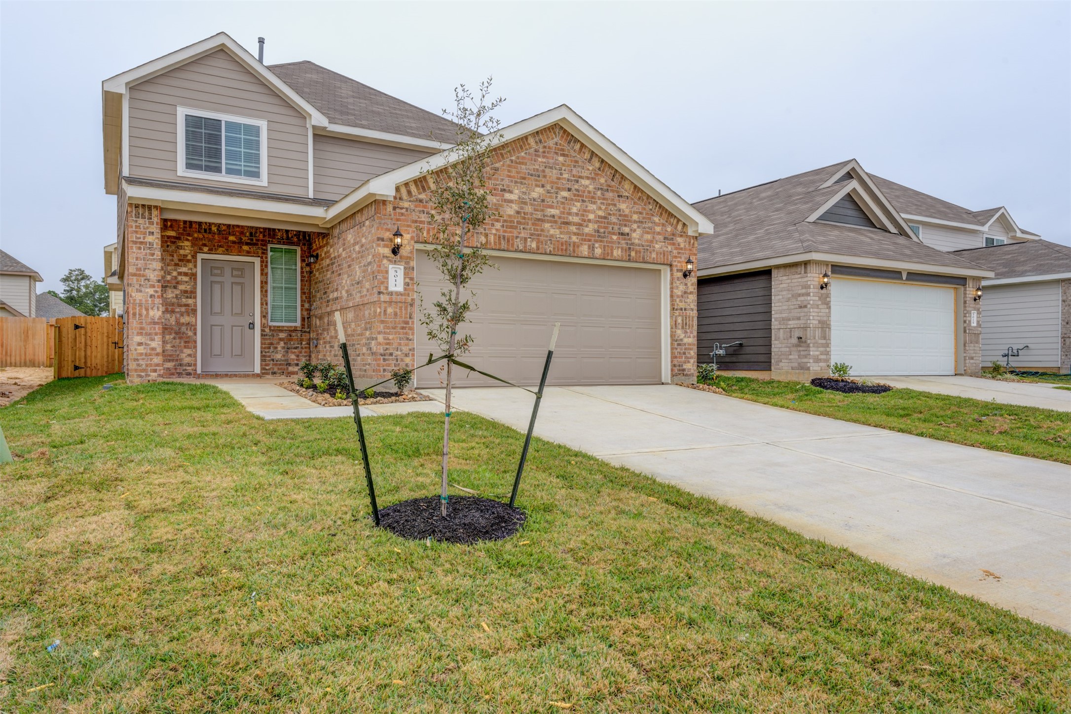 5011 Blue Jacaranda Way Spring Spring, TX 77373 - Photo 3 of 32 a house that has a big yard and a large tree in it