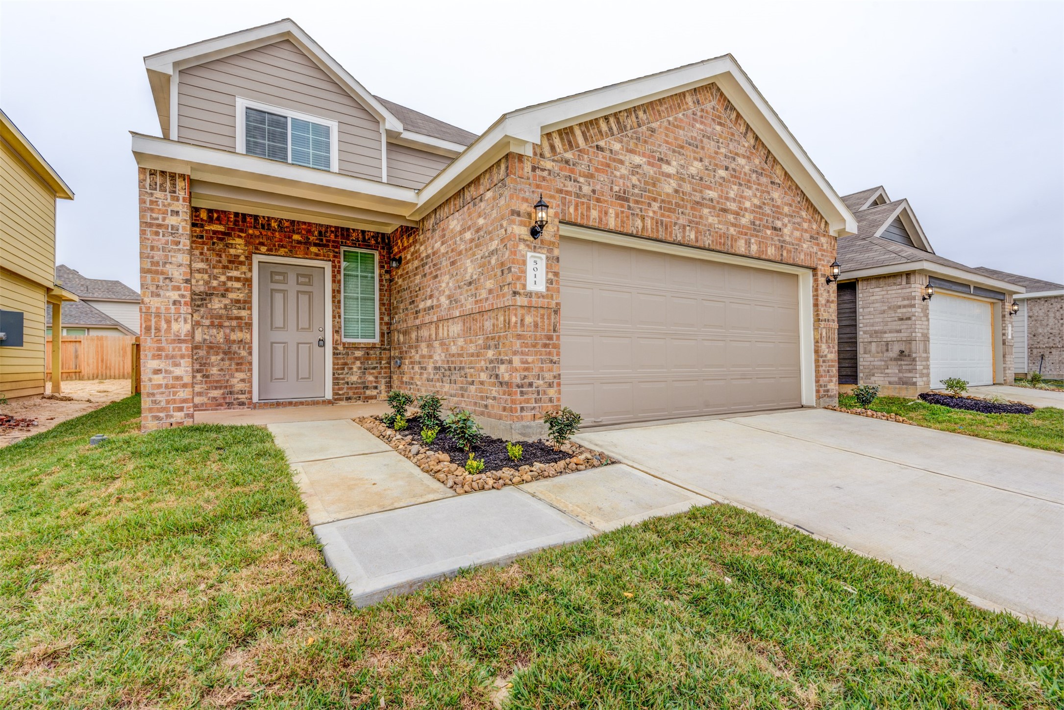 5011 Blue Jacaranda Way Spring Spring, TX 77373 - Photo 4 of 32 a front view of a house with a yard and garage