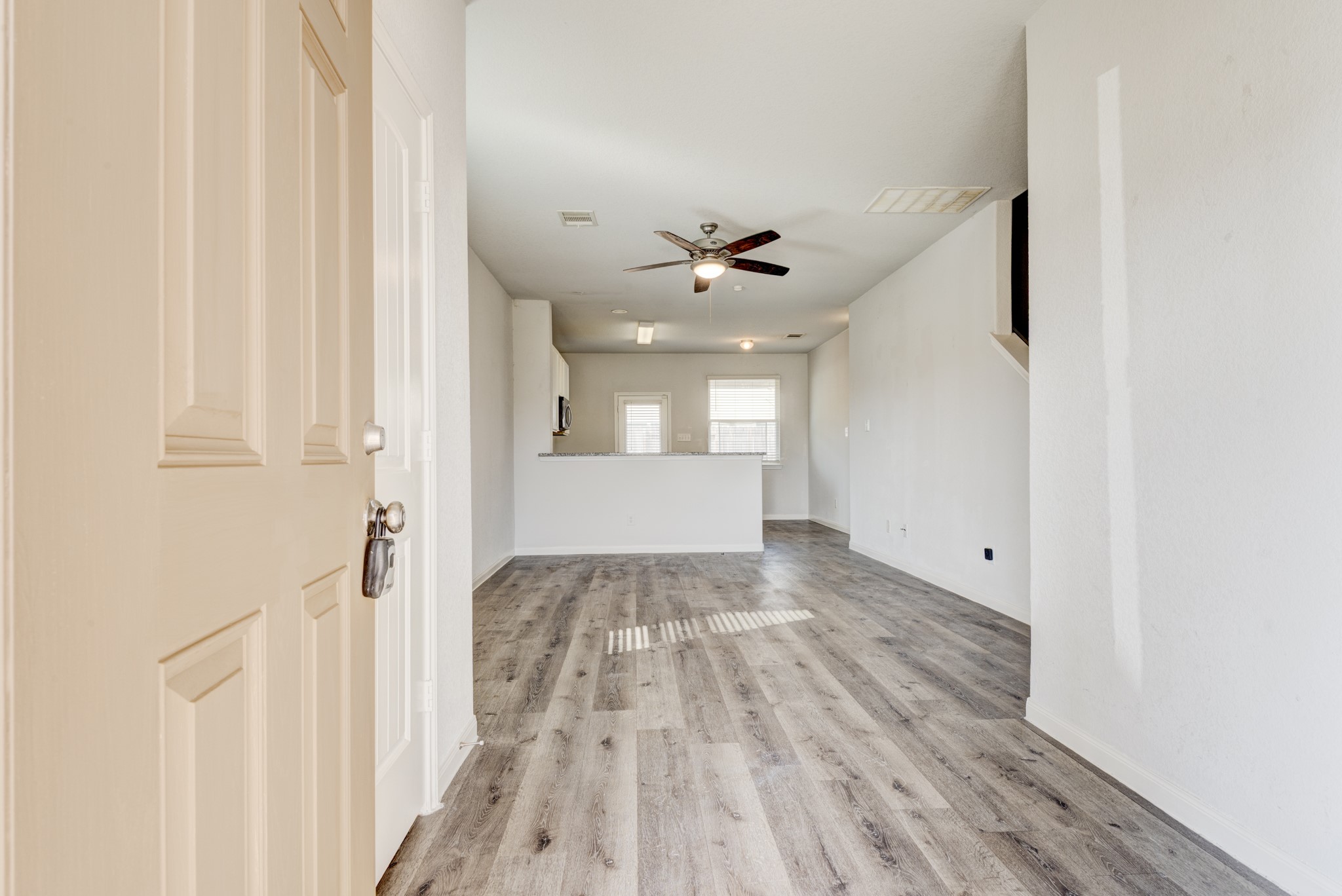 5011 Blue Jacaranda Way Spring Spring, TX 77373 - Photo 5 of 32 a view of a hallway with wooden floor and a bathroom
