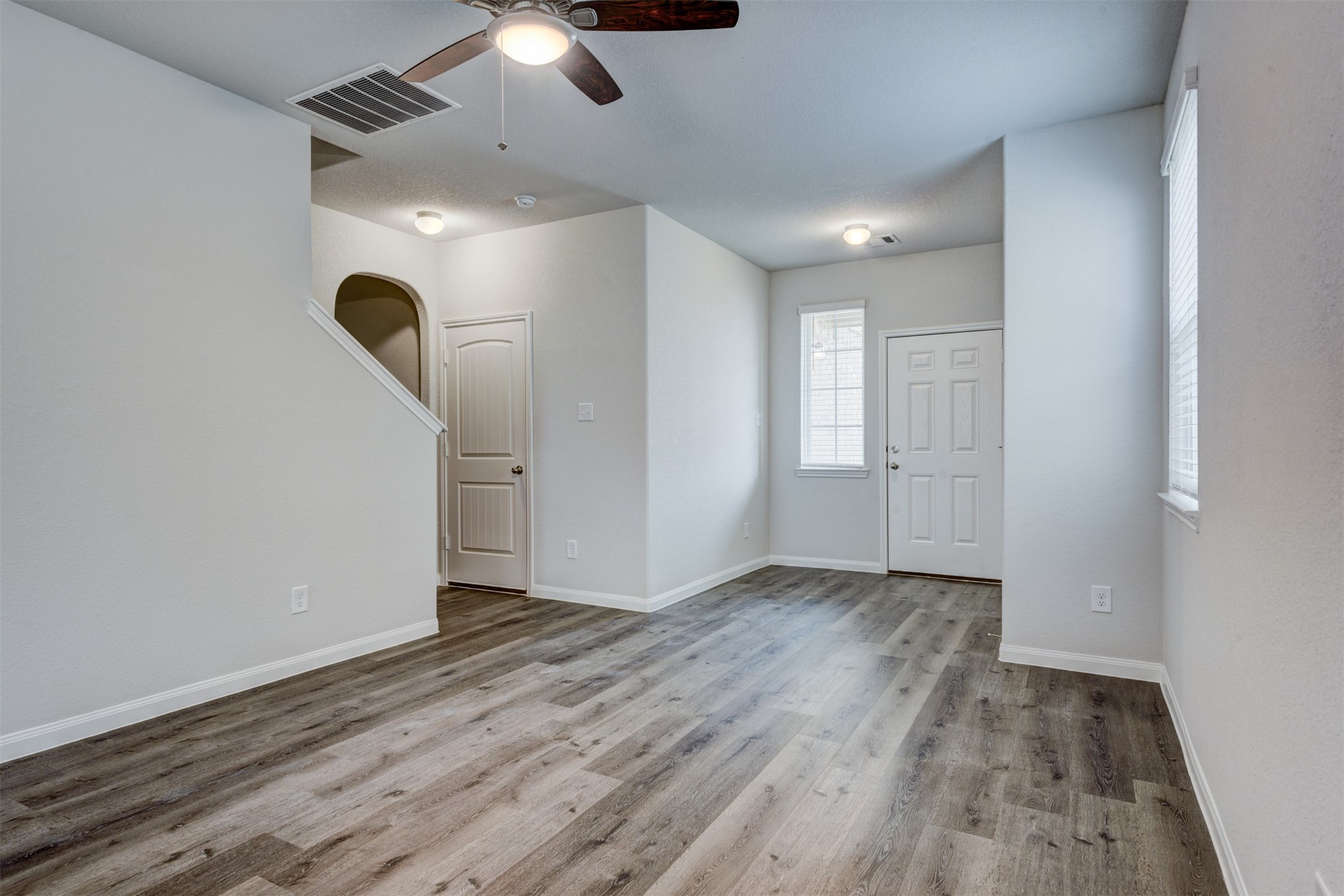 5011 Blue Jacaranda Way Spring Spring, TX 77373 - Photo 6 of 32 an empty room with wooden floor and windows