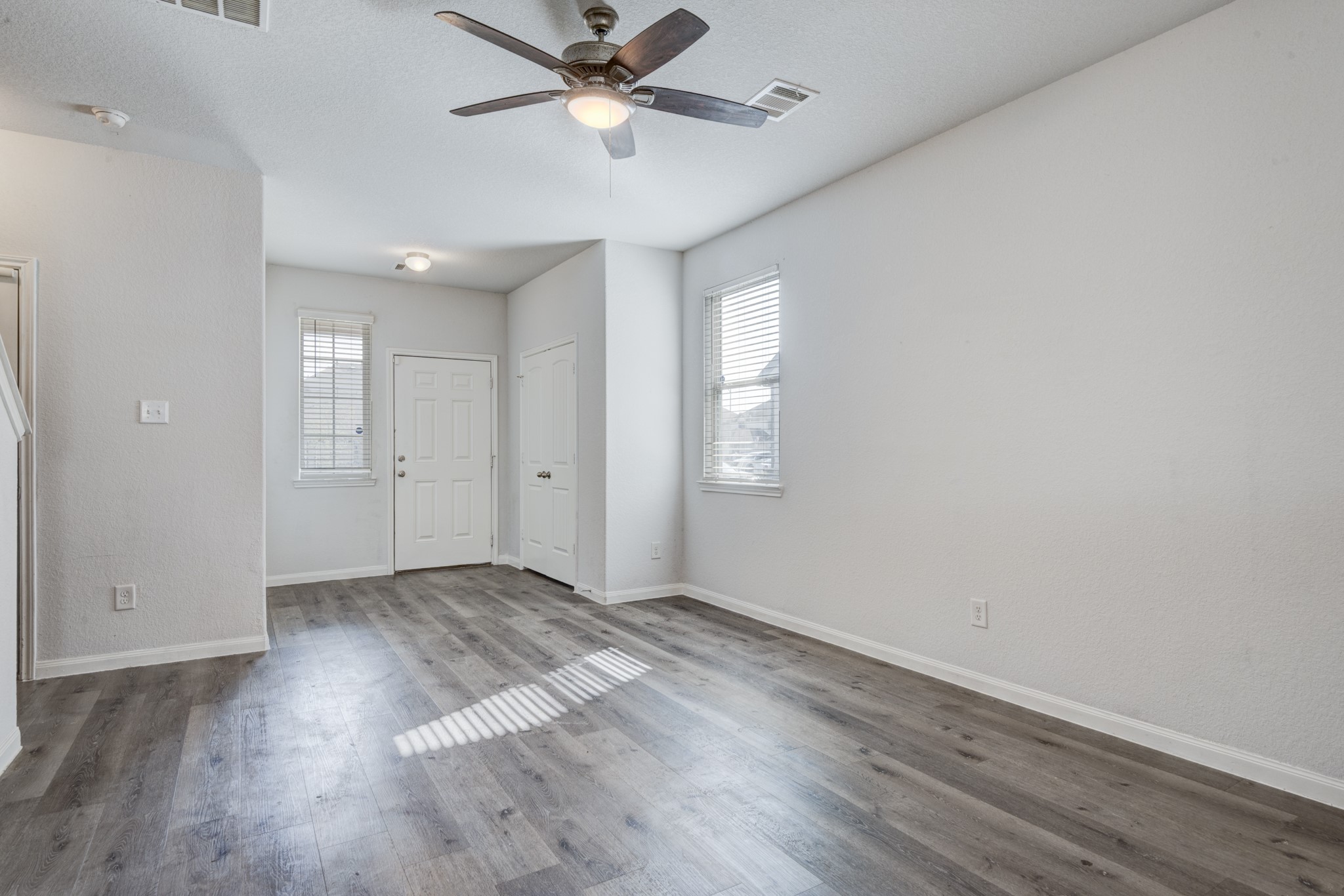 5011 Blue Jacaranda Way Spring Spring, TX 77373 - Photo 7 of 32 an empty room with wooden floor fan and windows