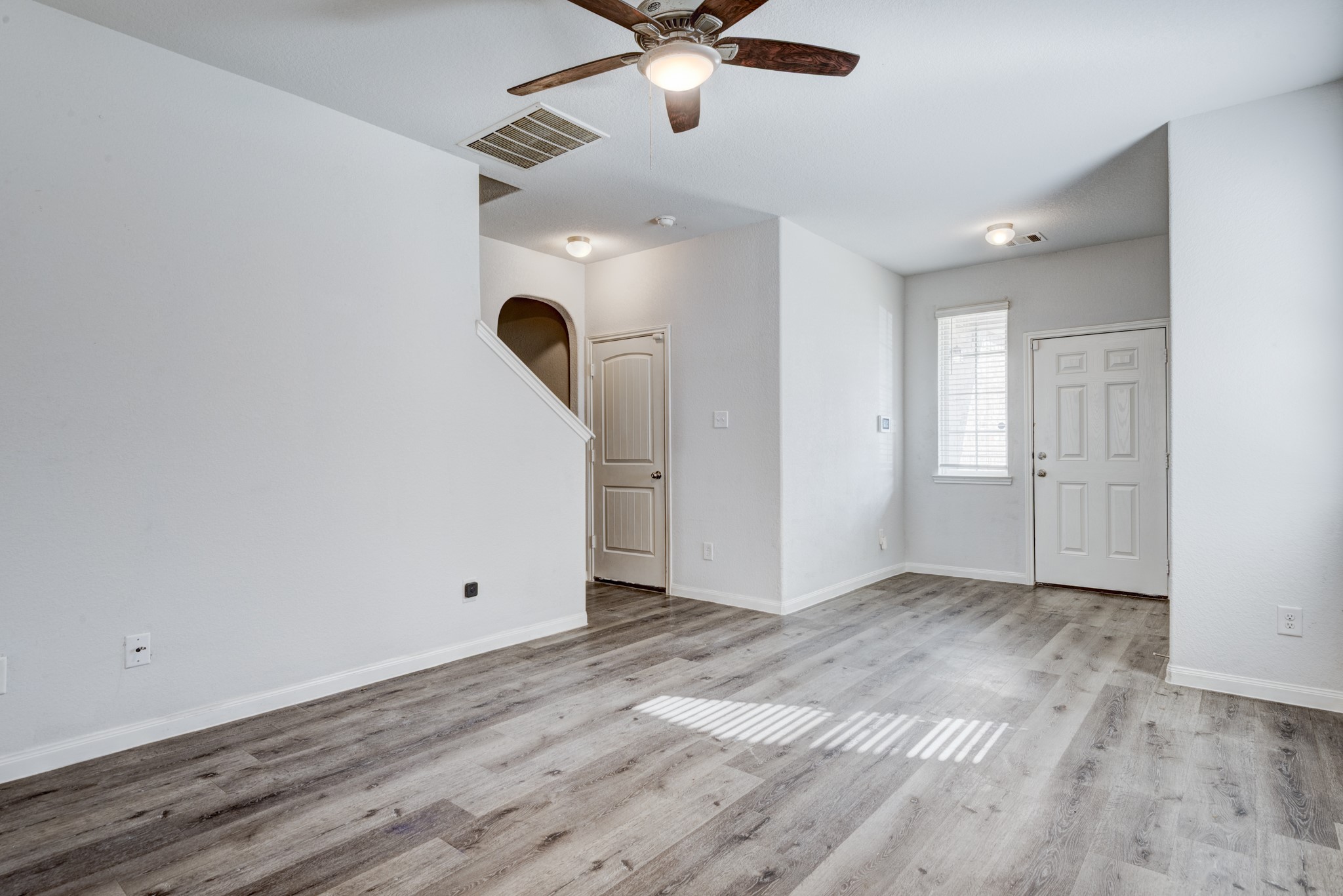 5011 Blue Jacaranda Way Spring Spring, TX 77373 - Photo 8 of 32 wooden floor in an empty room with a window