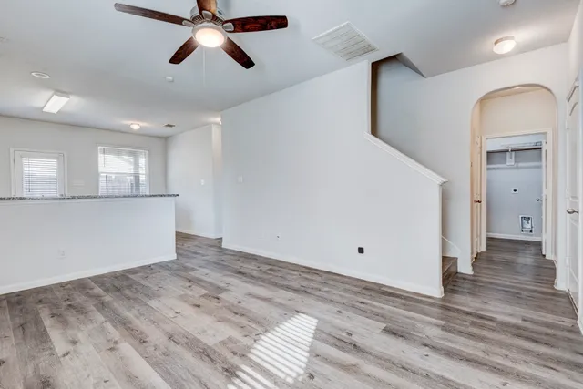 a view of empty room with wooden floor