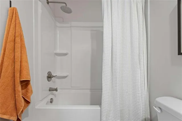 a bathroom with a shower curtain and a curtain