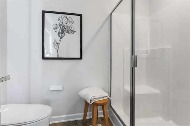 a bathroom with a toilet and a shower