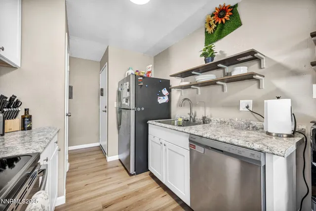 a kitchen with stainless steel appliances granite countertop a refrigerator and a stove