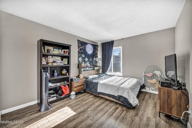 a bedroom with bed and a window