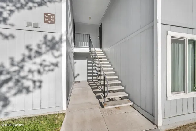 a view of a hallway with wooden floor and entryway