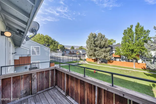 a view of a wooden deck and a yard