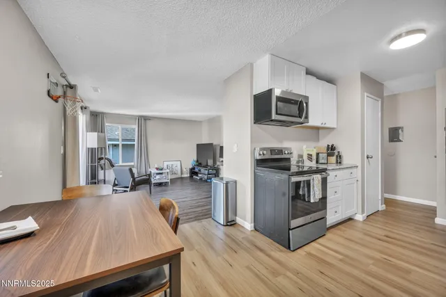 a kitchen with sink stove and refrigerator