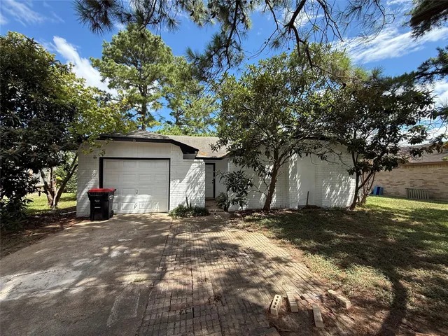 a view of a house with a yard and garage