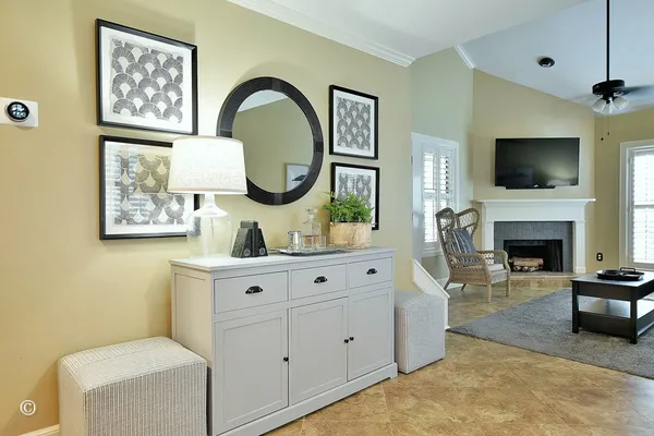 a living room with furniture a flat screen tv and a fireplace