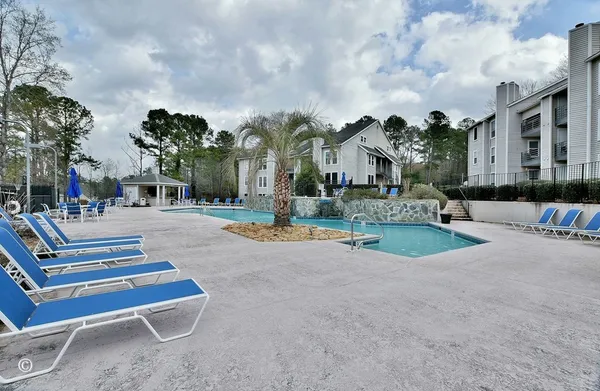 a swimming pool with outdoor seating and yard