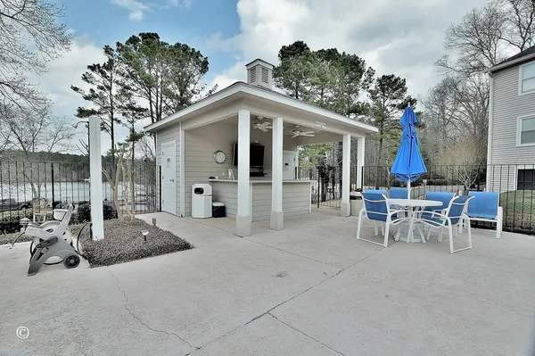 a view of a house with backyard and sitting area